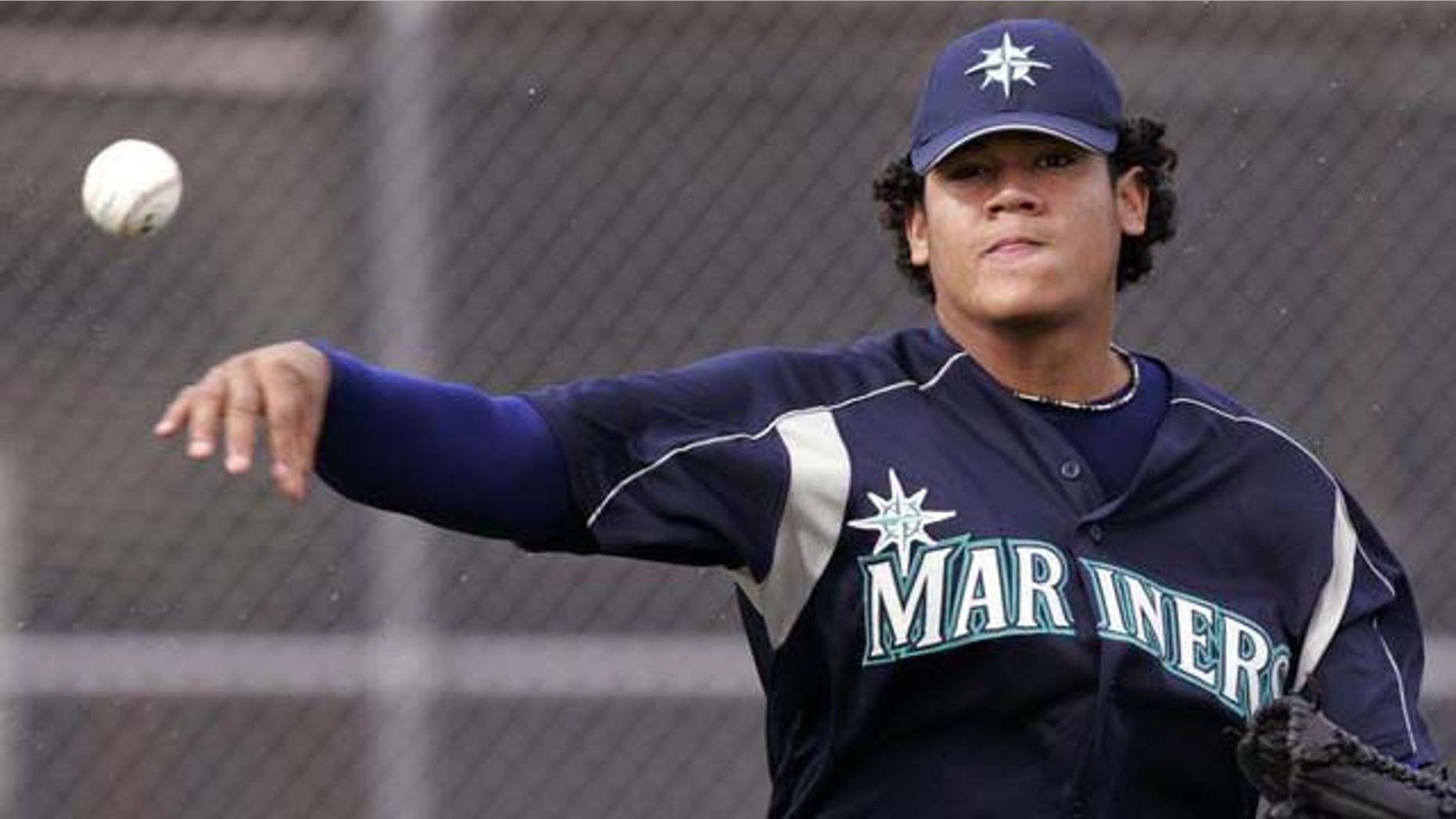 Seattle Mariners pitcher Felix Hernandez throws to first during a bunting drill on the first day of spring training workouts for pitchers and catchers Thursday, Feb. 17, 2005, in Peoria, Ariz. (AP Photo/Elaine Thompson)