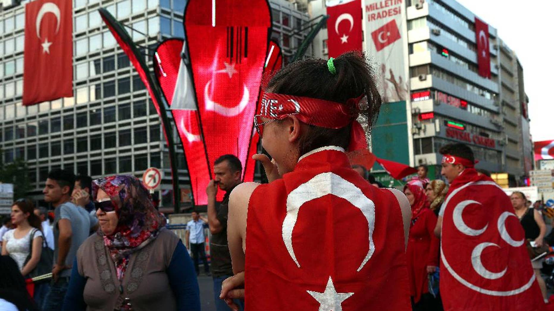 People with Turkish flags gather at the 15 July martyrs square in Ankara, Turkey, on Friday, July 29, 2016. The government crackdown in the coup's aftermath has strained Turkey's ties with key allies including the United States. (AP Photo/Ali Unal)