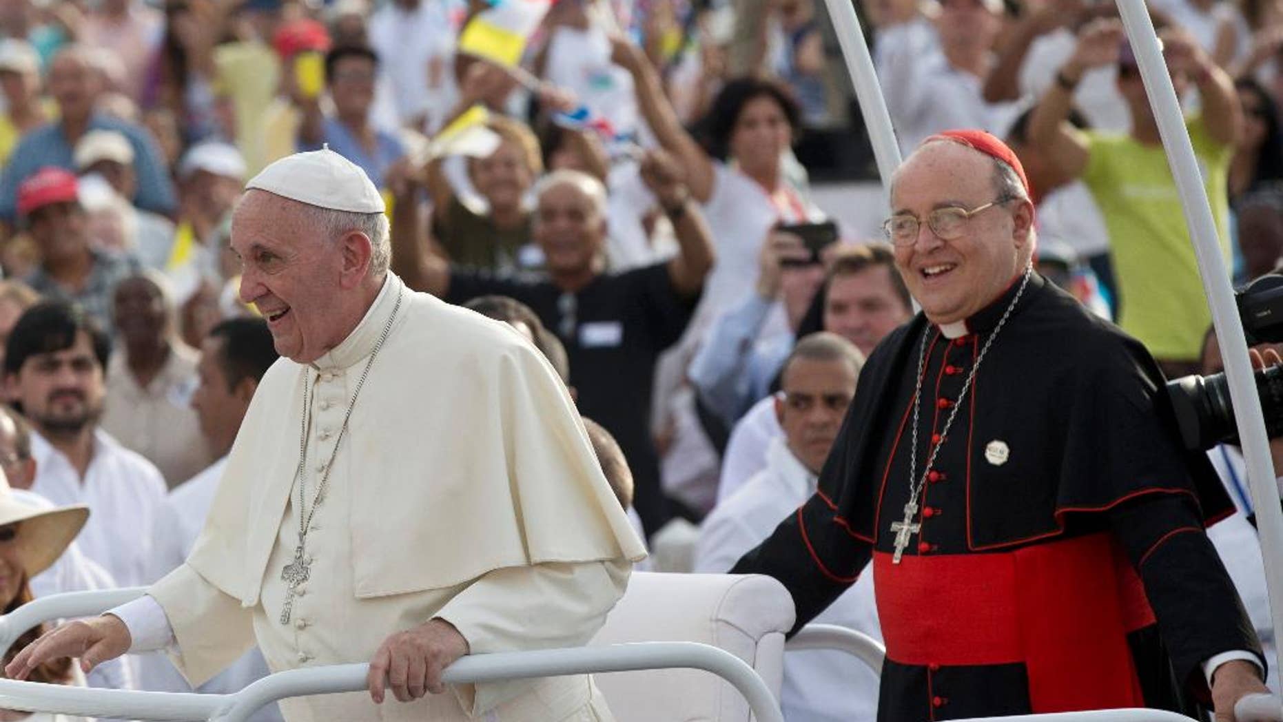 Cuba's Cardinal Jaime Ortega, right, stands behind Pope Francis in the popemobile as they arrive for Mass at Revolution Plaza in Havana, Cuba, Sunday, Sept. 20, 2015. During Mass Sunday, Ortega thanked the pope for his work promoting detente between Havana and Washington and called for reconciliation between Cubans living on the island and elsewhere. Ortega was among many priests sent to military-run agricultural camps in the 1960s after Fidel Castro declared Cuba to be socialist and accused prominent Catholics of trying to topple him. (Ismael Francisco/Cubadebate Via AP)