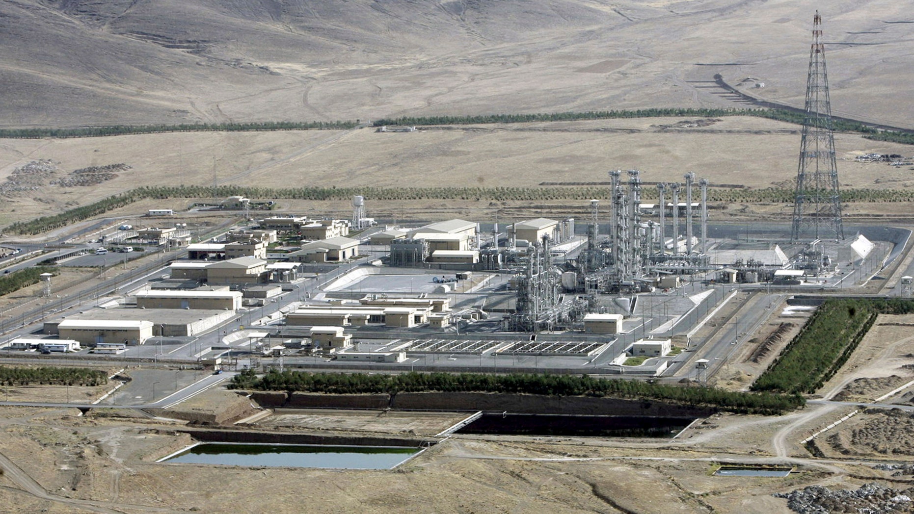 FILE- In this Saturday, Aug. 26, 2006 file photo, an aerial view of a heavy-water production plant in the central Iranian town of Arak. Iran's reformers and moderate conservatives welcomed an agreement between Iran and six world powers on how to implement a nuclear deal struck in November, saying it will shore up Iran's sanctions-hit economy but hardliners still remain opposed. The six-nation group - the five permanent members of the U.N. Security Council plus Germany - and Iran have agreed to start implementing the terms of the historic interim deal from Jan. 20. That will start a six-month clock for a final deal to be struck over the Islamic Republic's contested nuclear program. (AP Photo/ ISNA, Arash Khamoushi, File)