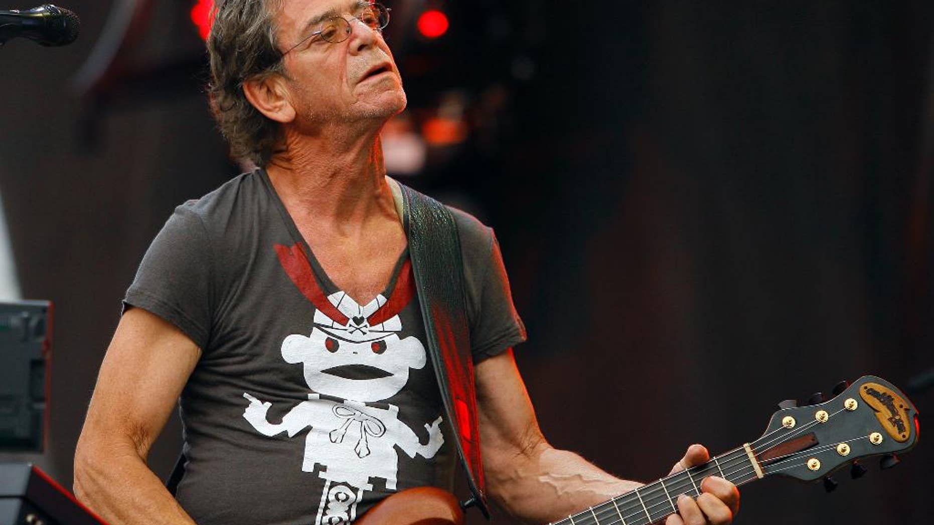 FILE - In this Sunday, Aug. 9, 2009 file photo, Lou Reed performs at the Lollapalooza music festival, in Chicago. The New York Public Library for the Performing Arts has acquired the complete archives of Lou Reed. The library and Reed’s wife, musician Laurie Anderson, made the announcement Thursday, March 2, 2017, on what would have been his 75th birthday. (AP Photo/John Smierciak, File)