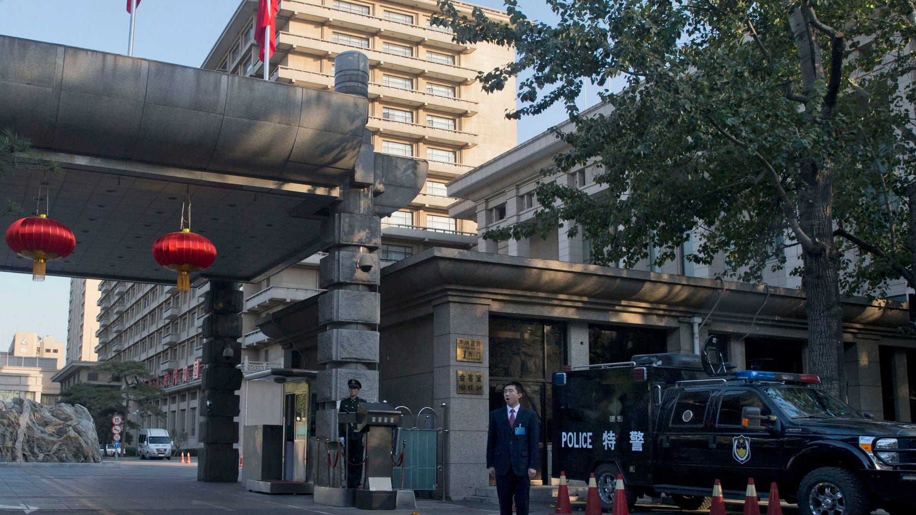Chinese security personnel guard the entrance to the Jingxi hotel where the Communist Party's 205-member Central Committee gathered over the weekend for its third annual plenum in Beijing Tuesday, Nov. 12, 2013. In a brief statement issued after the four-day Communist Party conference aimed at producing a reform blueprint for the next decade China's leaders have promised to give the free market an even bigger role as they overhaul the worn-out growth model of their slowing, government-dominated economy. (AP Photo/Ng Han Guan)