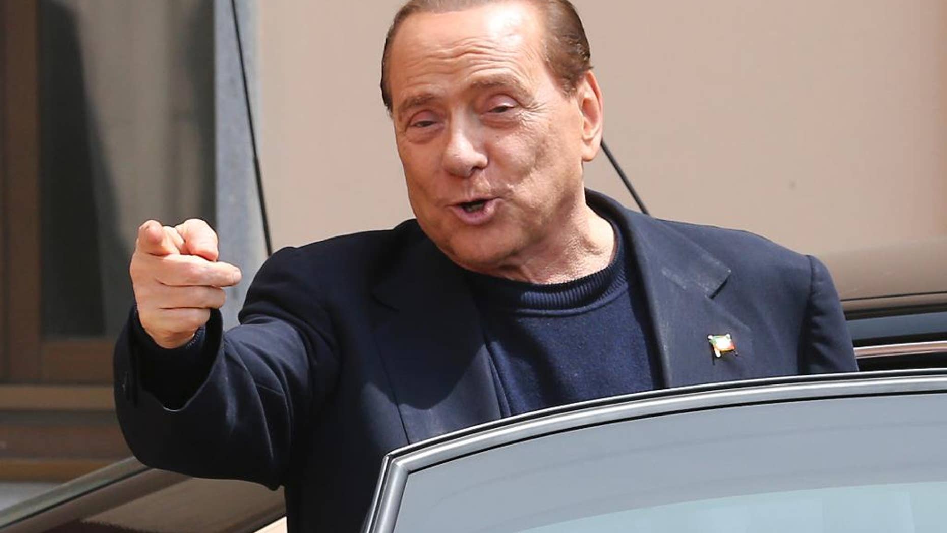 FILE - In this Friday, May 9, 2014 file photo, Silvio Berlusconi smiles as he leaves the "Sacra Famiglia" foundation in Cesano Boscone, near Milan, Italy. An Italian appeals court says former Premier Silvio Berlusconi could not be found guilty of paying for sex with a Moroccan teen because he appears to have been unaware of her age. The court on Thursday, Oct. 16, 2014 issued its lengthy reasoning behind its July decision to overturn a conviction against Berlusconi for paying for sex with a 17-year-old Moroccan, Karima el-Mahroug, then using his influence to cover it up. Both he and Mahroug denied ever having sex. (AP Photo/Antonio Calanni, Files)