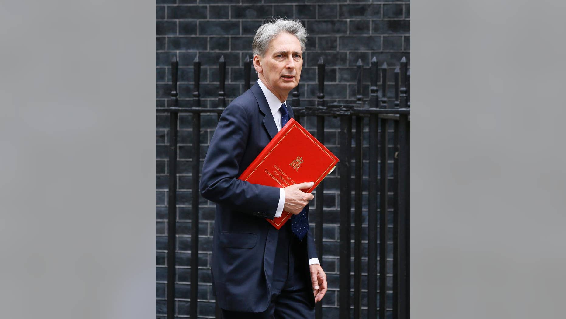 FILE - In this file photo dated Friday, May 13, 2016, Britain's Foreign Secretary Philip Hammond arrives at Downing Street in London. Britain's Treasury chief Philip Hammond said Saturday Aug. 13, 2016, in a funding guarantee that Britain will keep paying for European Union-funded agriculture, infrastructure and science projects even if Britain leaves the bloc. (AP Photo/Kirsty Wigglesworth, FILE)