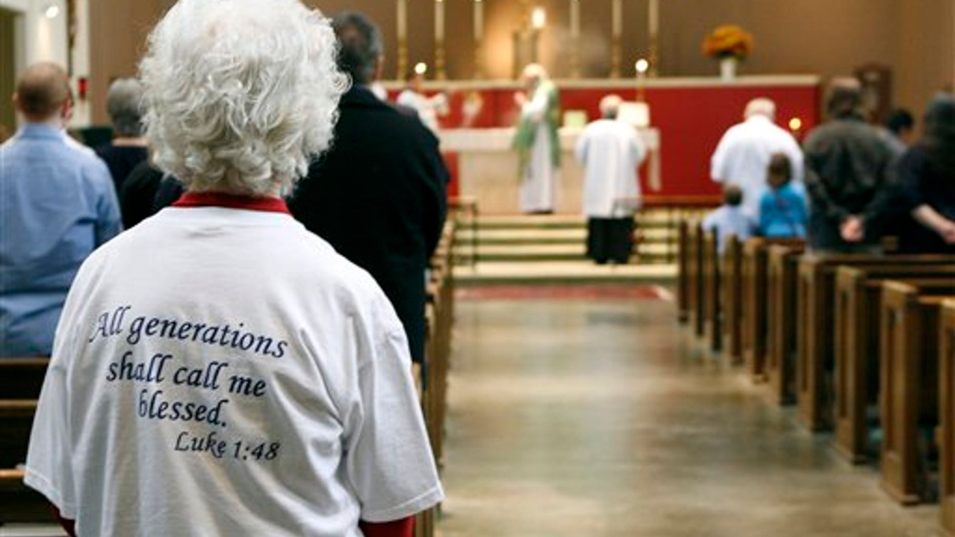 In this Sunday, Oct. 25, 2009 photo, Lavon Ferrell, left front, attends Sunday Mass at Saint Mary the Virgin Catholic Church in Arlington, Texas. The conservative church became a Roman Catholic church in 1994 after it left the Episcopal Church. (AP Photo/Amy Gutierrez)