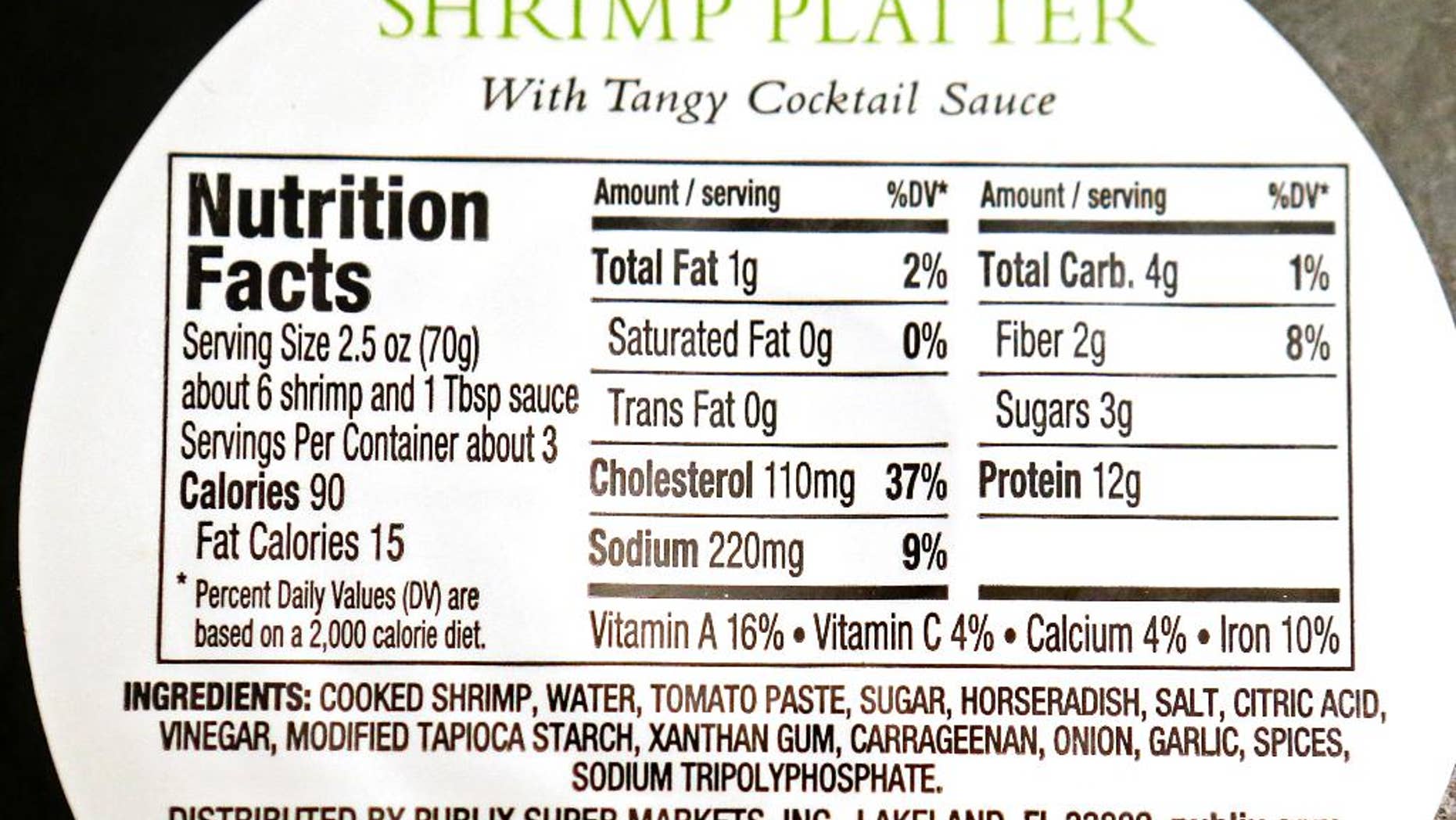 This Monday, Nov. 16, 2015 photo shows the back label of a Publix brand shrimp cocktail platter, a product of Thailand, purchased in Orlando, Fla. In November 2015, AP journalists followed and filmed trucks loaded with freshly peeled shrimp going from the Gig Peeling Factory in Samut Sakhon, Thailand to major Thai exporting companies, and then tracked it globally. They also traced similar connections from another factory raided six months earlier and interviewed more than two dozen workers from both sites. The shrimp made its way into the supply chains of major food stores and retailers in all 50 U.S. states. (AP Photo/John Raoux)