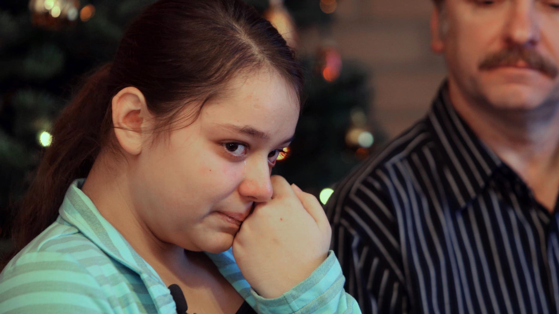 Dec. 22, 2012: Kristina Shevchenko, Clackamas Town Center shooting victim, talks to reporters for first time at her house as her father Veniamin looks on.