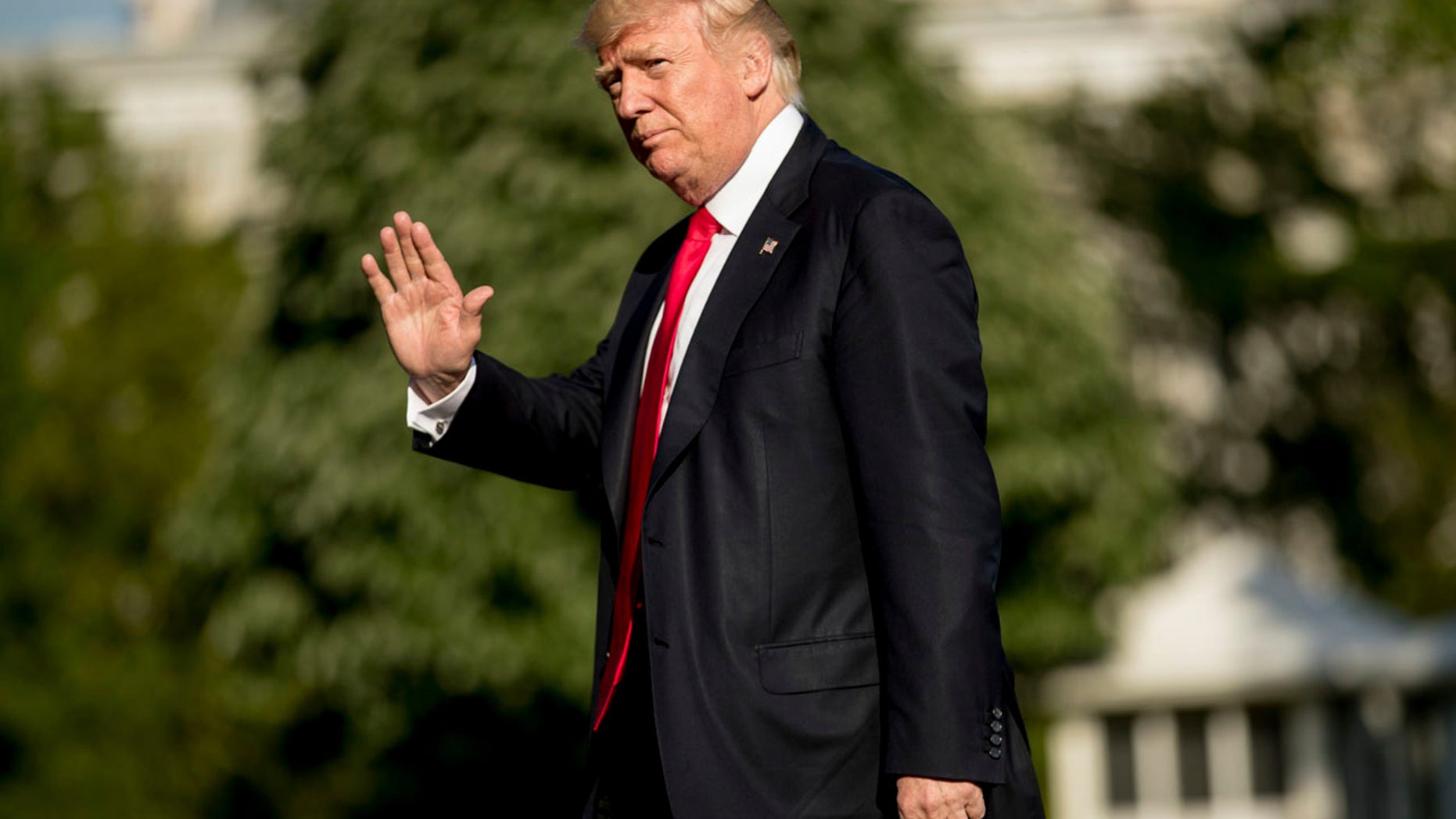 President Donald Trump walks across the South Lawn as he arrives at the White House in Washington, Friday, April 28, 2017.