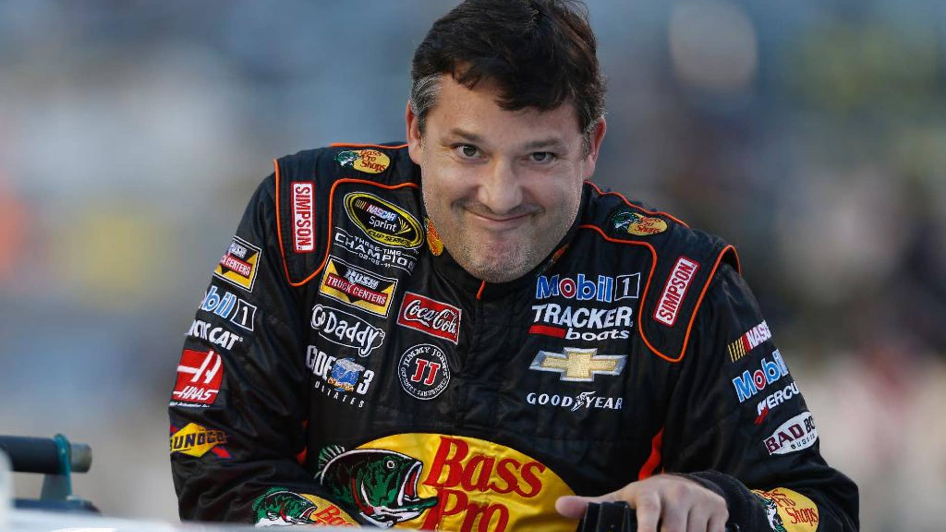 Tony Stewart looks to the crowd during driver introductions prior to the start of the NASCAR Sprint Cup race at Richmond International Raceway in Richmond, Va., Saturday, Sept. 6, 2014. (AP Photo/Steve Helber)