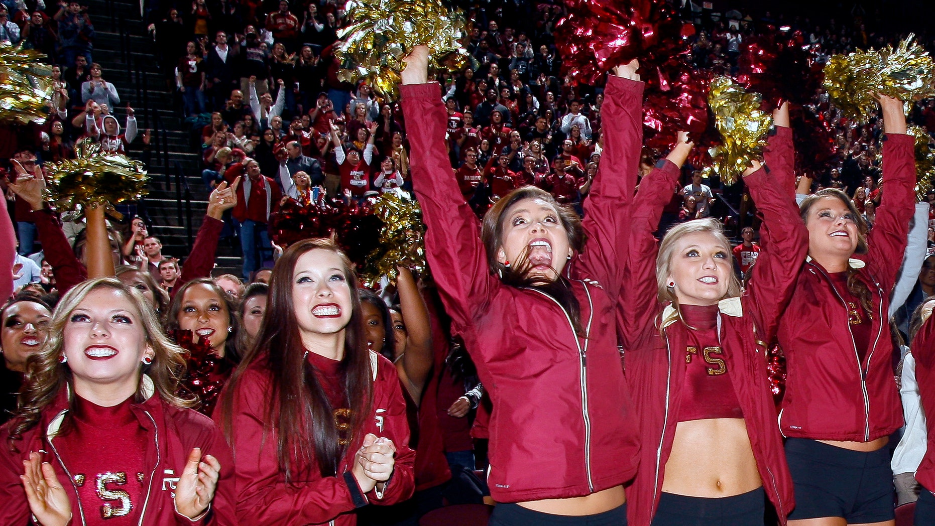 Florida State Golden Girls cheerleaders react as they watch Florida State score a touchdown on a 30-foot screen at the Tallahassee Leon County Civic Center in the second quarter of the NCAA BCS National Championship college football game against Auburn, Monday, Jan. 6, 2014, in Tallahassee, Fla. (AP Photo/Phil Sears)