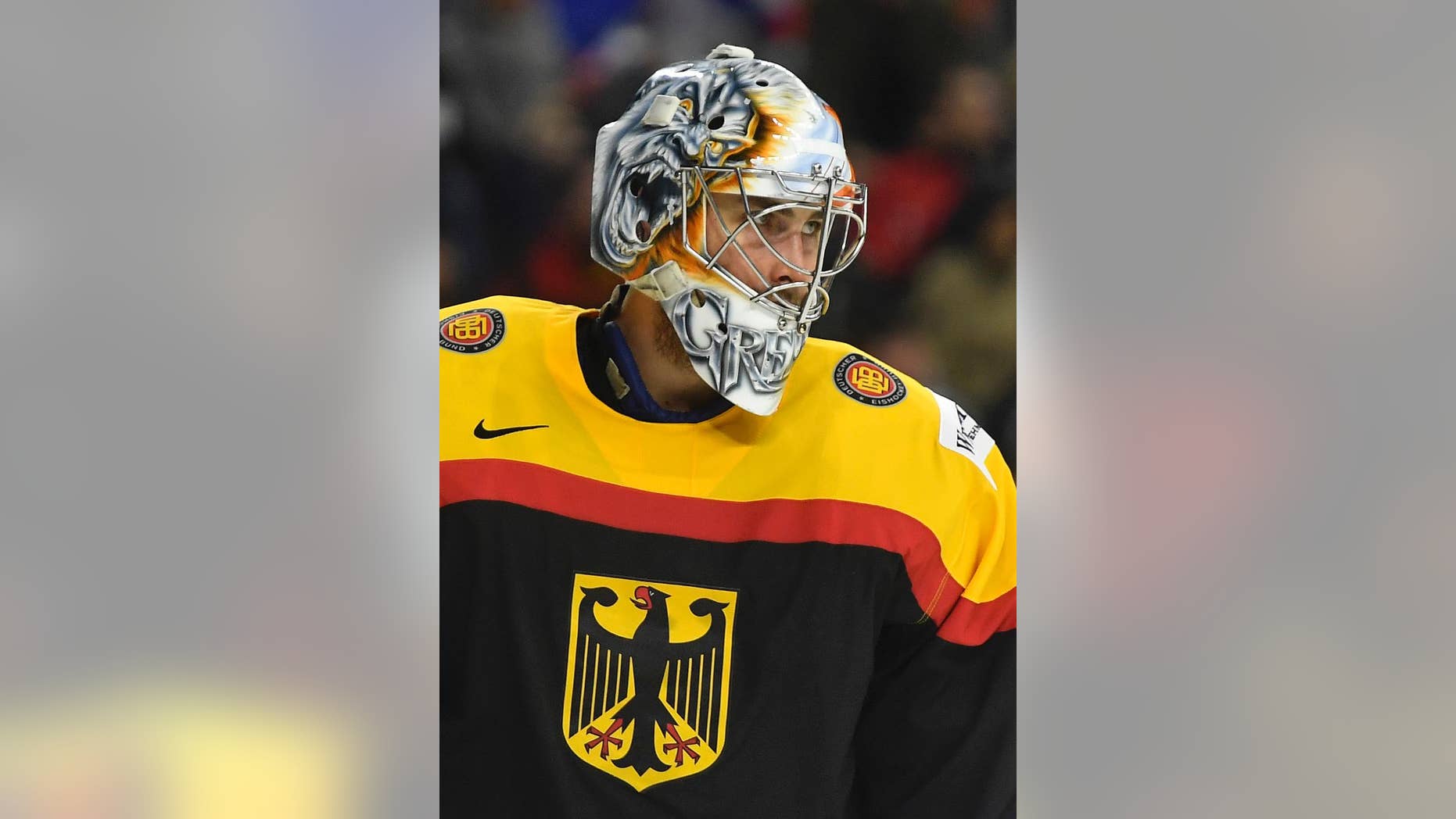 Germany's goalkeeper Thomas Greiss watches disappointed under his mask during the Ice Hockey World Championships group A match between Germany and Russia at the LANXESS arena in Cologne, Germany, Monday, May 8, 2017. (AP Photo/Martin Meissner)