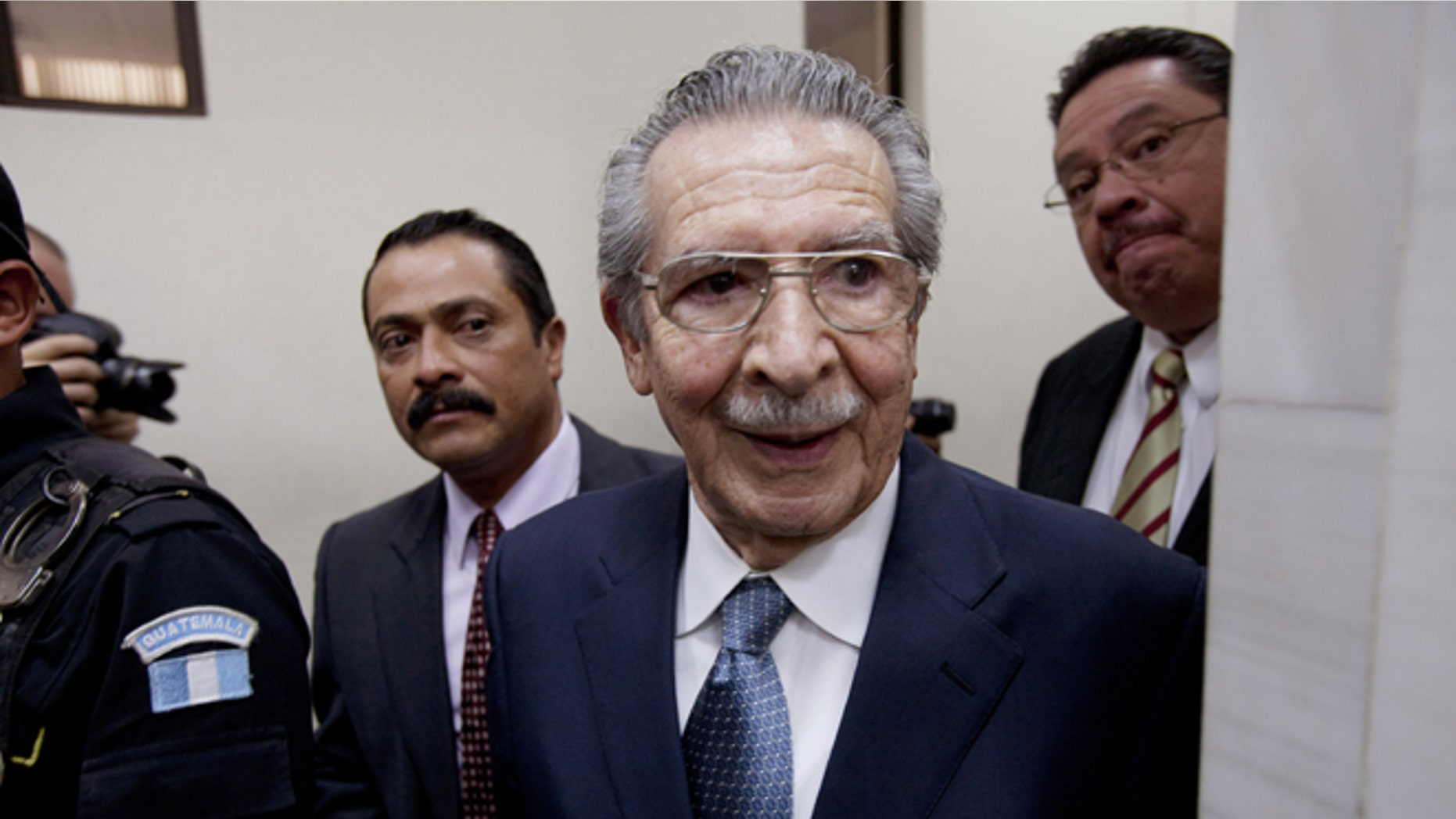 FILE - In this Jan. 24, 2013 file photo, Guatemala's former dictator Efrain Rios Montt (1982-1983) leaves the courtroom after his pre-trial hearing in Guatemala City. With his trial set to start Tuesday, March 19, 2013, prosecutors hope to painstakingly prove through a detailed recreation of the military chain of command that Rios Montt must have had knowledge of the massacres of Mayan Indians and others in the Guatemalan highlands. Because he held absolute power over the U.S.-backed military government, his failure to stop the slaughter is proof of his guilt, prosecutors and lawyers for victims say. (AP Photo/Moises Castillo, File)