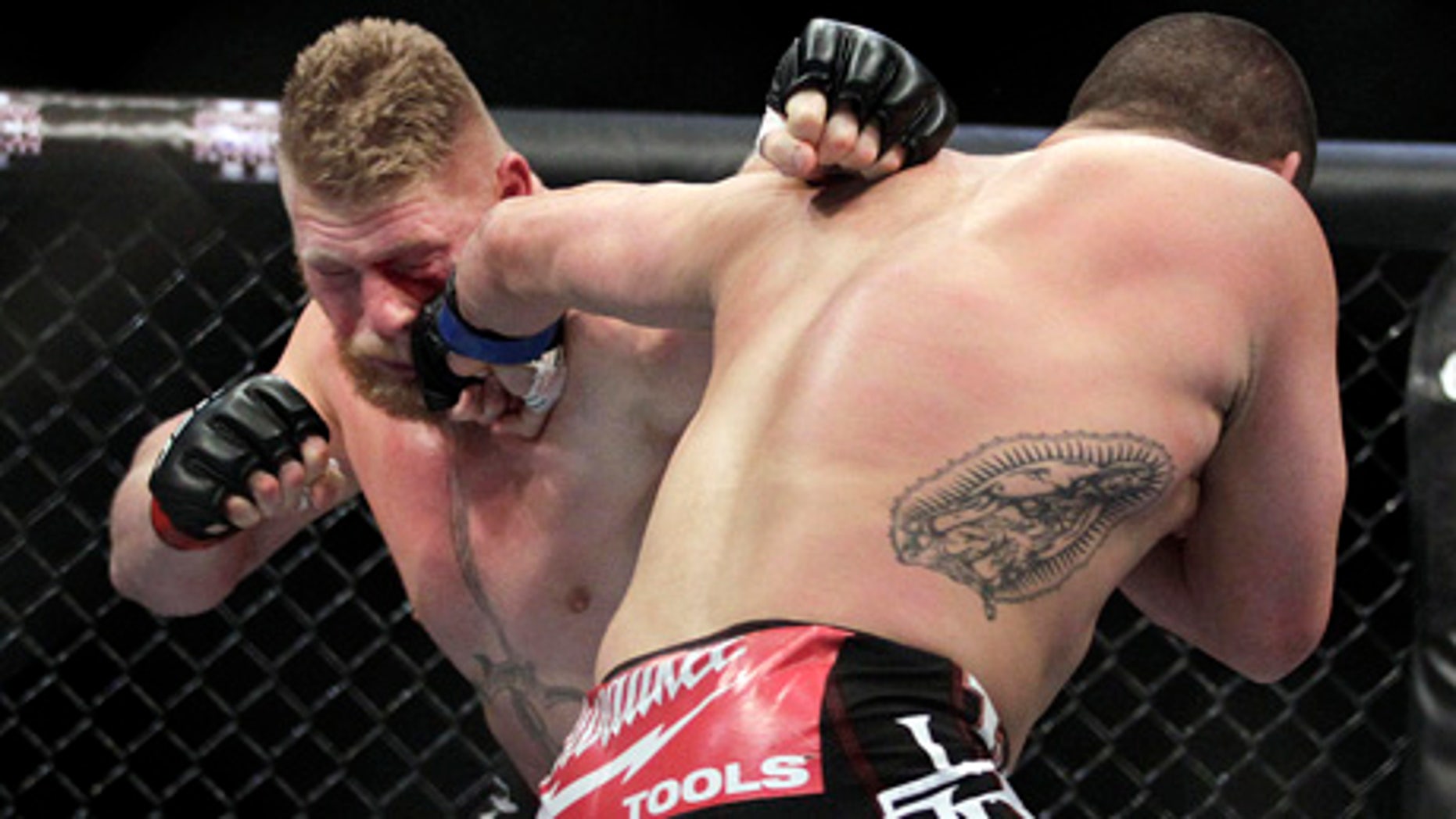 Cain Velasquez, right, lands a left to the face of Brock Lesnar during a UFC mixed martial arts match in Anaheim, Calif., Saturday, Oct. 23, 2010. Velasquez won by TKO in the first round. (AP Photo/Jae C. Hong)