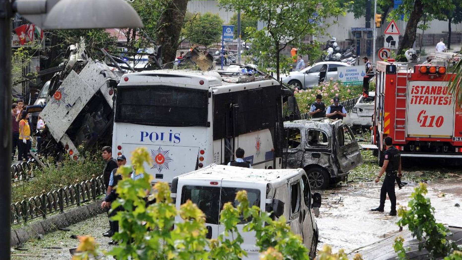 Turkish security officials and firefighters at the site of a bus explosion Tuesday.