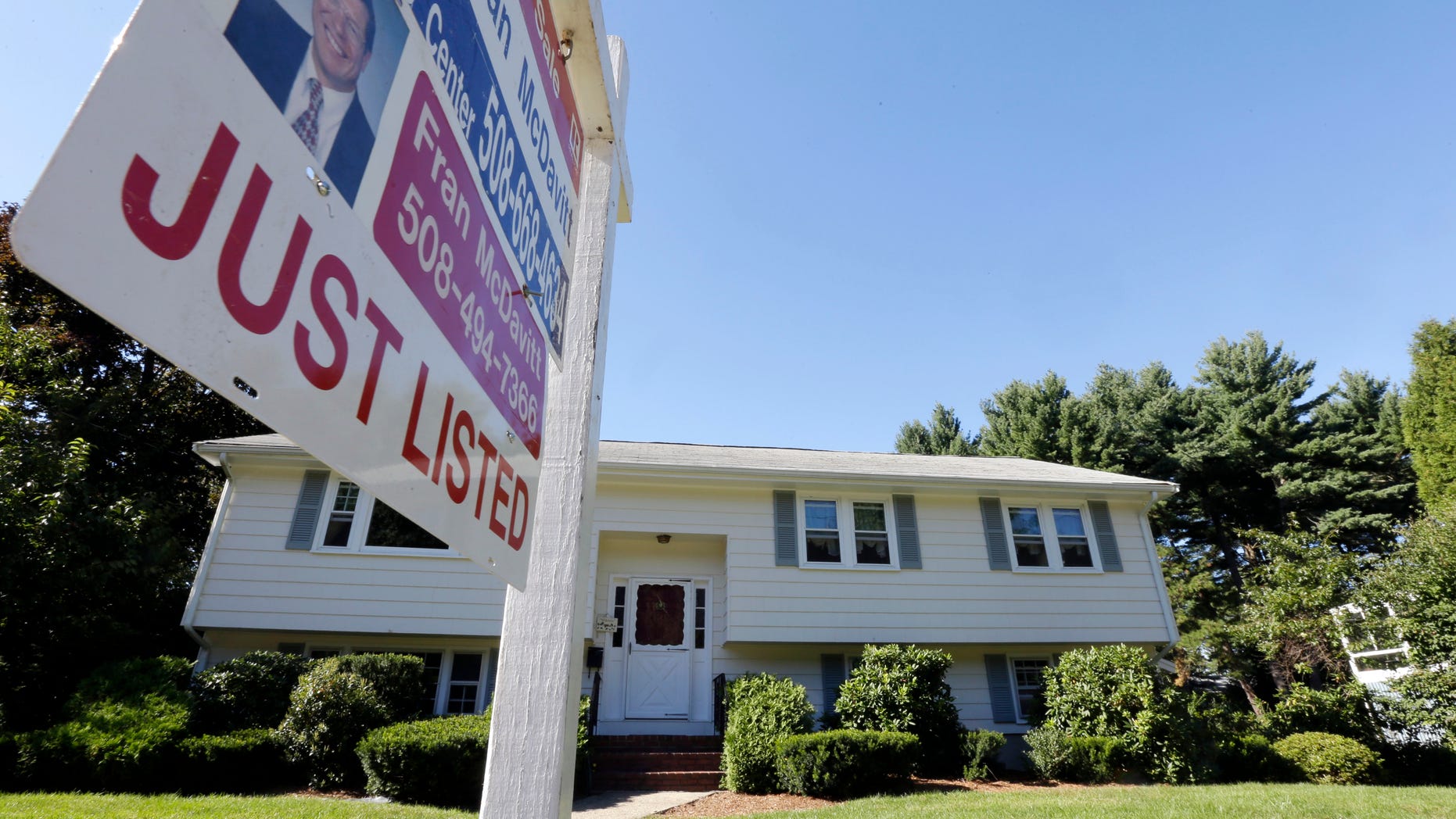 FILE - In this Wednesday, Sept. 18, 2013, file photo, a "For Sale" sign hangs in front of a house in Walpole, Mass. Standard & Poor's releases the S&P Case-Shiller index of home prices for August, on Tuesday, Oct. 29, 2013. (AP Photo/Steven Senne, File)