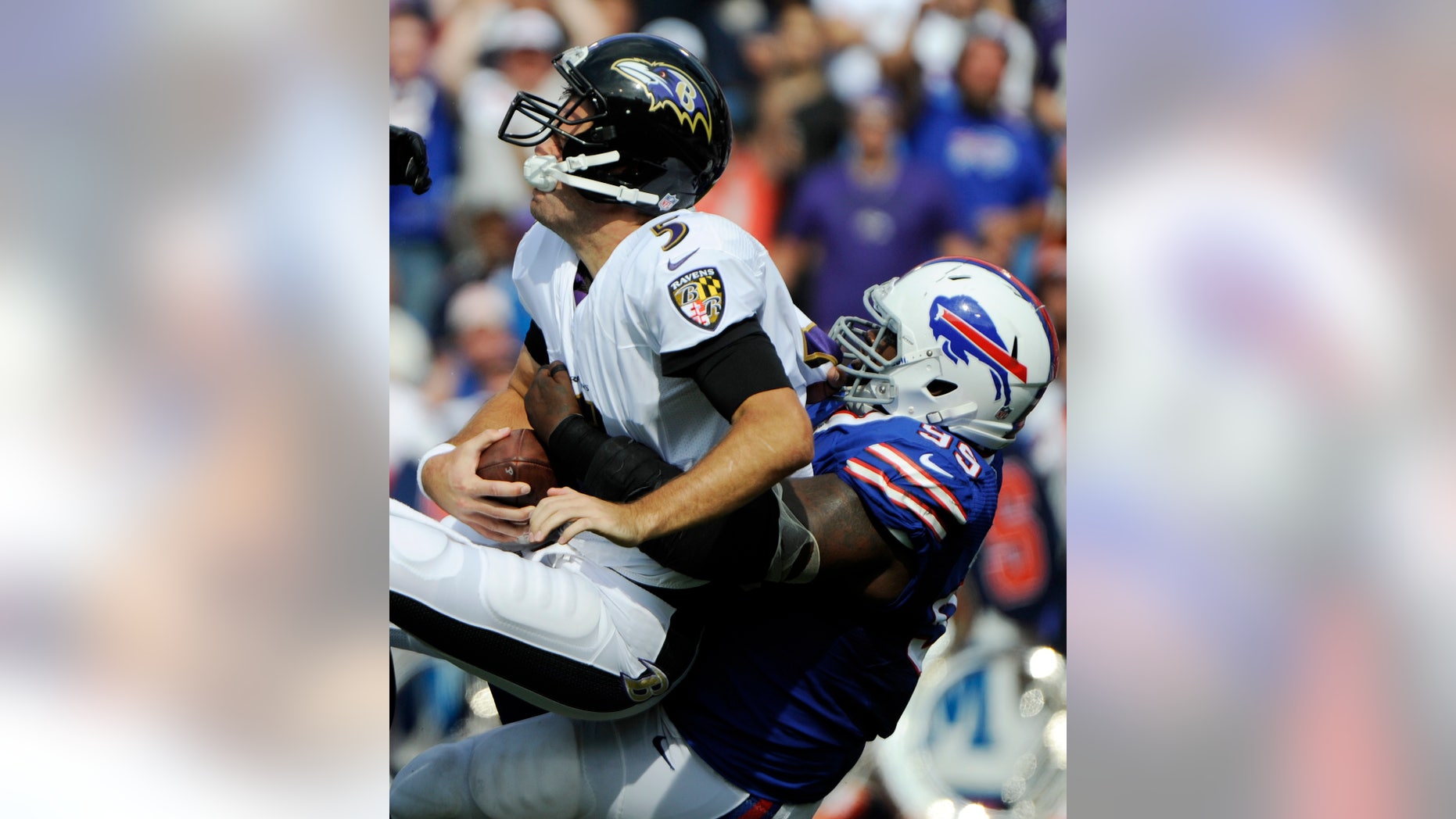Baltimore Ravens quarterback Joe Flacco (5) is sacked by Buffalo Bills defensive tackle Marcell Dareus (99) during the first half of an NFL football game on Sunday, Sept. 29, 2013, in Orchard Park, N.Y. (AP Photo/Gary Wiepert)