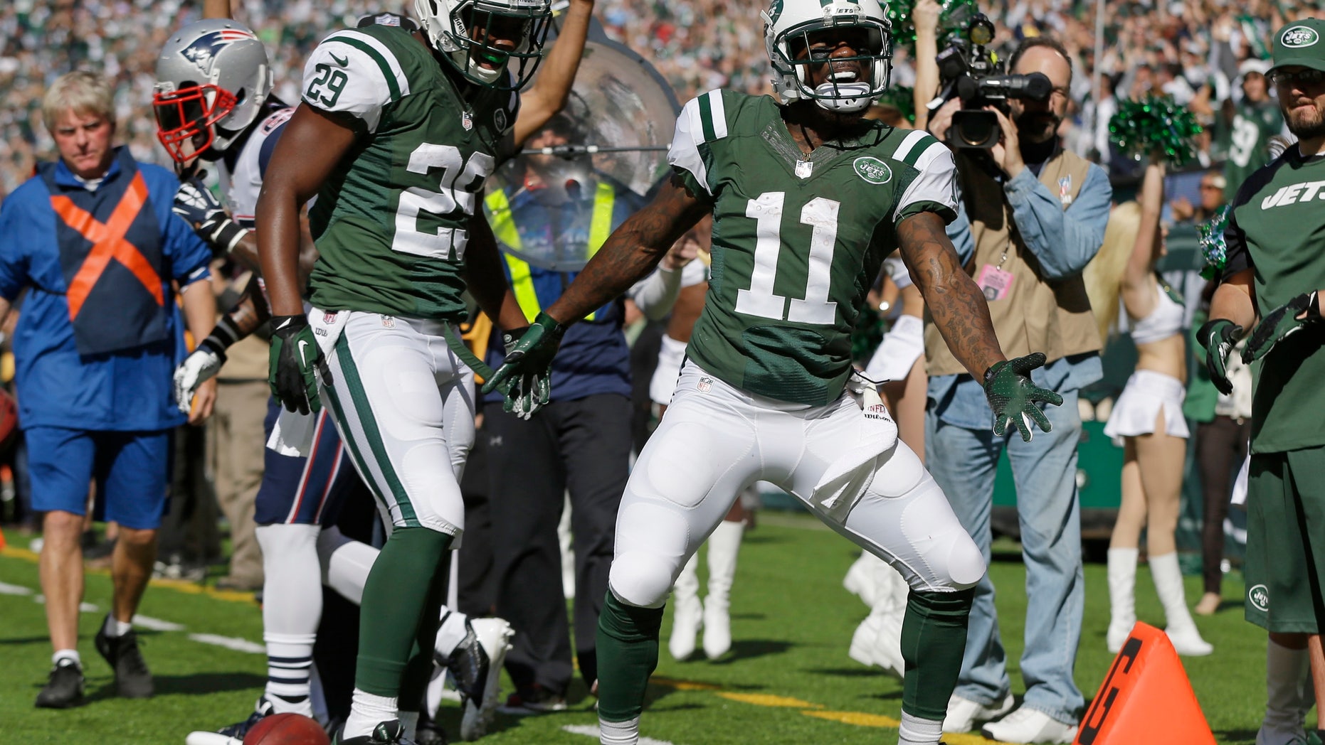 New York Jets wide receiver Jeremy Kerley (11) and Bilal Powell (29) celebrate a touchdown by Kerley during the first half of an NFL football game against the New England Patriots Sunday, Oct. 20, 2013 in East Rutherford. (AP Photo/Seth Wenig)