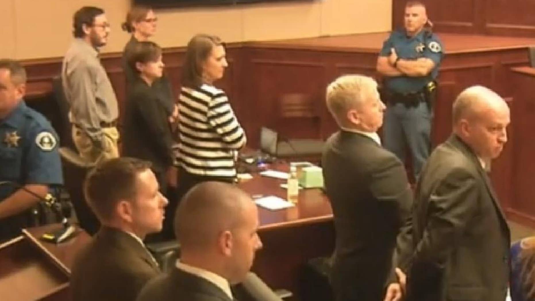 In this image made from Colorado Judicial Department video, Defendant James Holmes, top left in tan shirt, defense attorneys, top left, and prosecuting attorneys watch as the jury exits the courtroom after delivering their sentencing verdict in the Colorado theater shooting trial in Centennial, Colo., Friday, Aug. 7, 2015. Holmes will be sentenced to life in prison without parole after the jury failed to agree Friday on whether he should get the death penalty. (Colorado Judicial Department via AP, Pool)