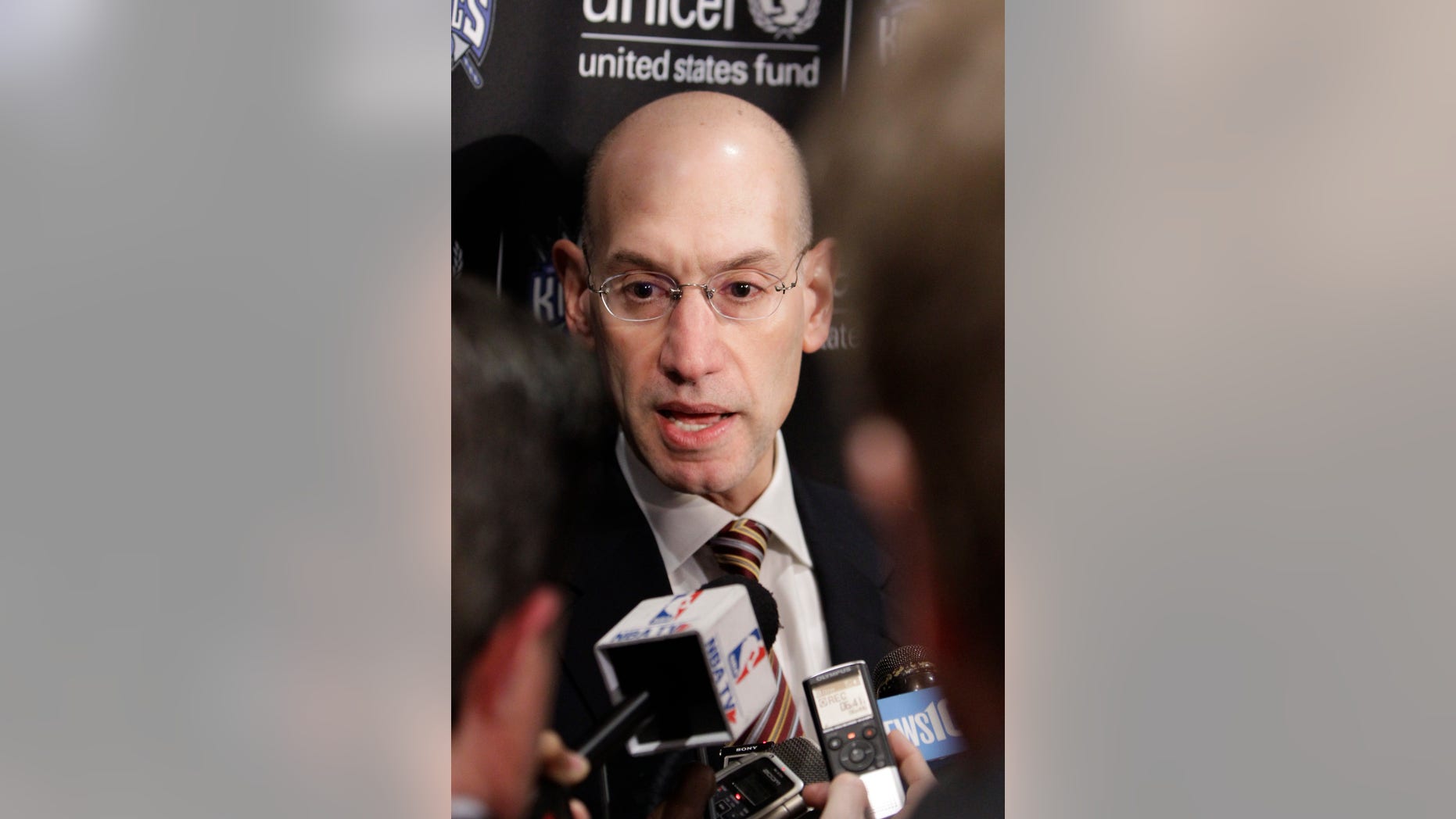 Adam Silver, the new NBA Commissioner, talks with reporters during the half time of an NBA basketball game between the Sacramento Kings and the Toronto Raptors in Sacramento, Calif., Wednesday, Feb. 5, 2014. Silver replaced David Stern Feb. 1, who retired after 30 years as the head of the NBA.(AP Photo/Rich Pedroncelli)