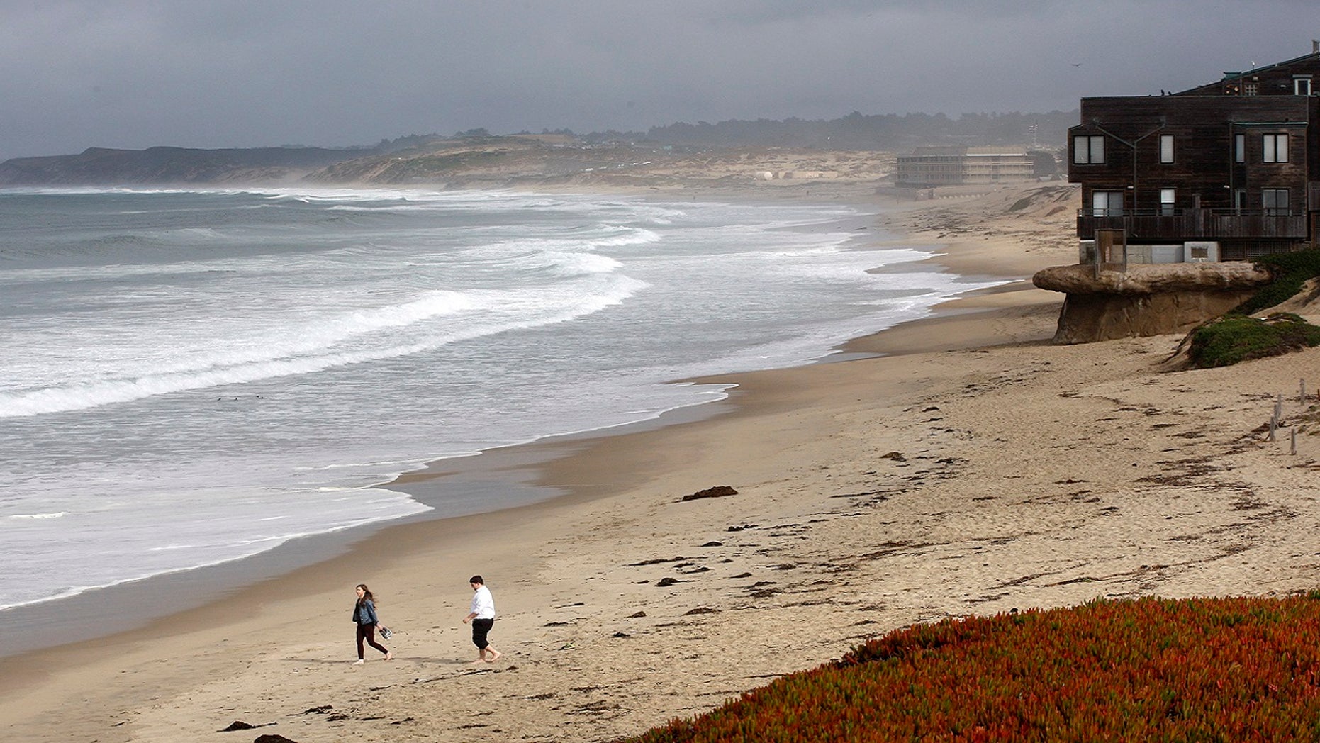 Beachgoers ignore the beach closure signs posted at Monterey State Beach in Monterey, Calif., Jan. 22, 2018.