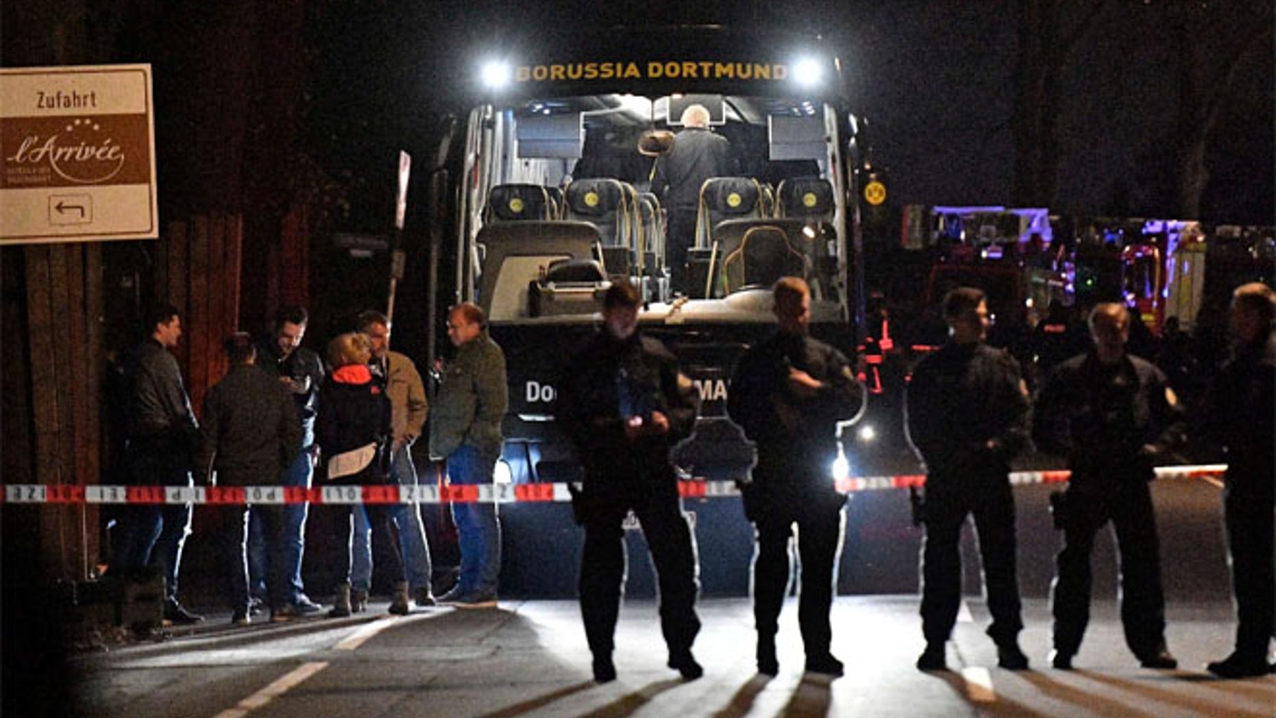 FILE 2017: Authorities stand in front of Dortmund's damaged team bus after explosions which injured two people before the Champions League quarterfinal soccer match between Borussia Dortmund and AS Monaco in Dortmund, western Germany.