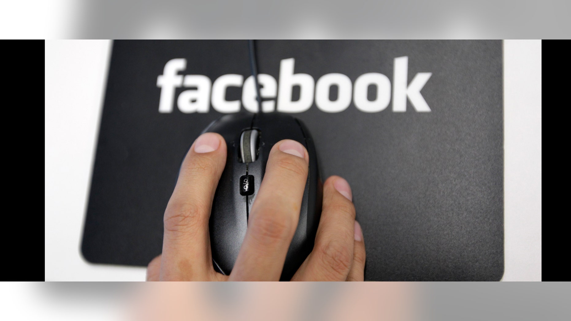 FILE - In this Tuesday, Dec. 13, 2011, file photo, a Facebook User Operations Safety Team worker looks at reviews at Facebook headquarters in Menlo Park, Calif. The Washington Post and The Guardian reported Thursday, June 6, 2013, the existence of a program used by the NSA and FBI that scours the nation's main Internet companies, extracting audio, video, photographs, emails, documents and connection logs to help analysts track a person's movements and contacts. (AP Photo/Paul Sakuma, File)
