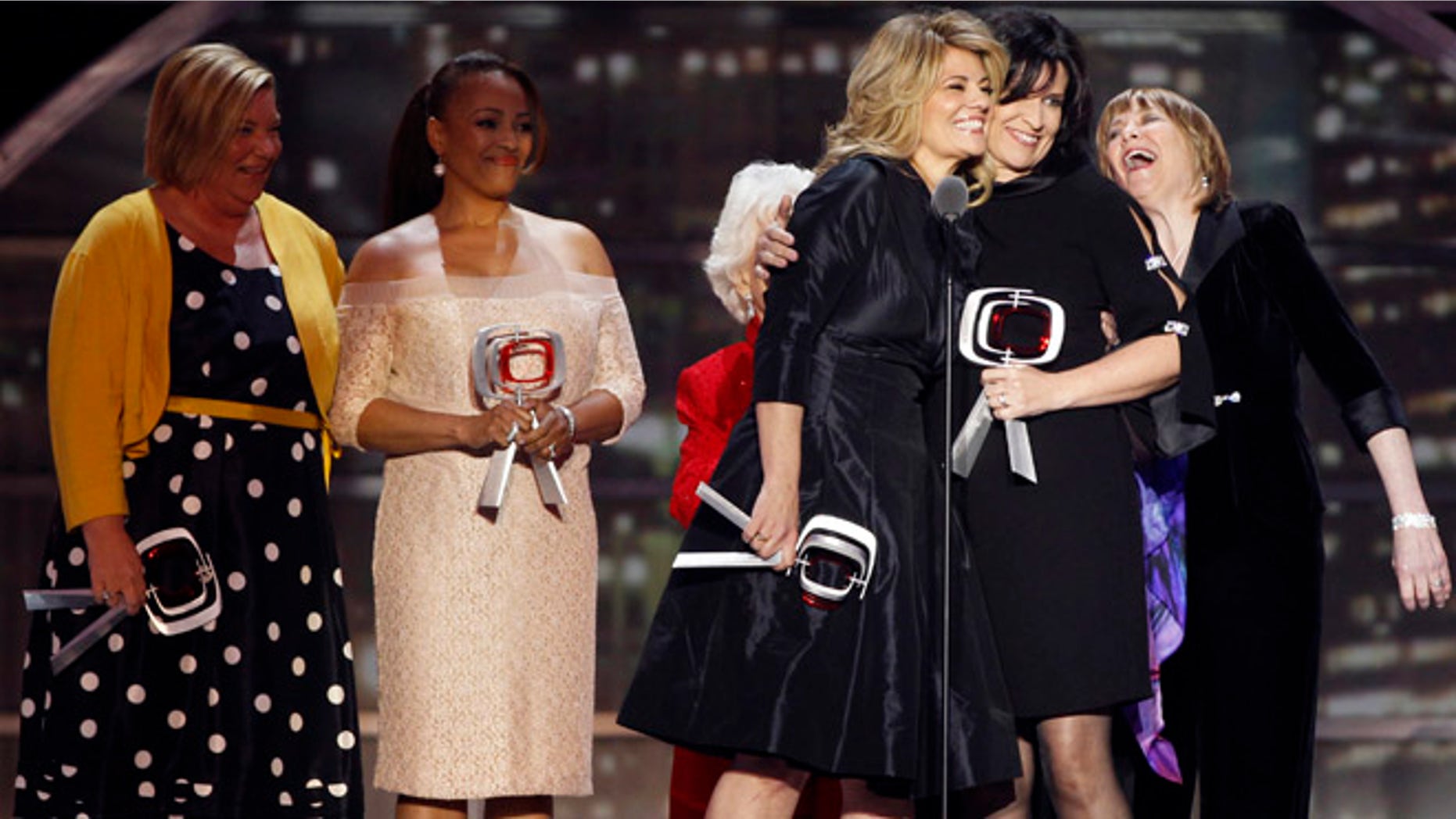 Actresses Nancy McKeon (2nd R) and Lisa Whelchel (C) laugh as they accept the "Pop Culture" award with the cast of the television show "Facts of Life" during the 2011 TV Land Awards in New York April 10, 2011. REUTERS/Lucas Jackson (UNITED STATES - Tags: ENTERTAINMENT) - RTR2L36P