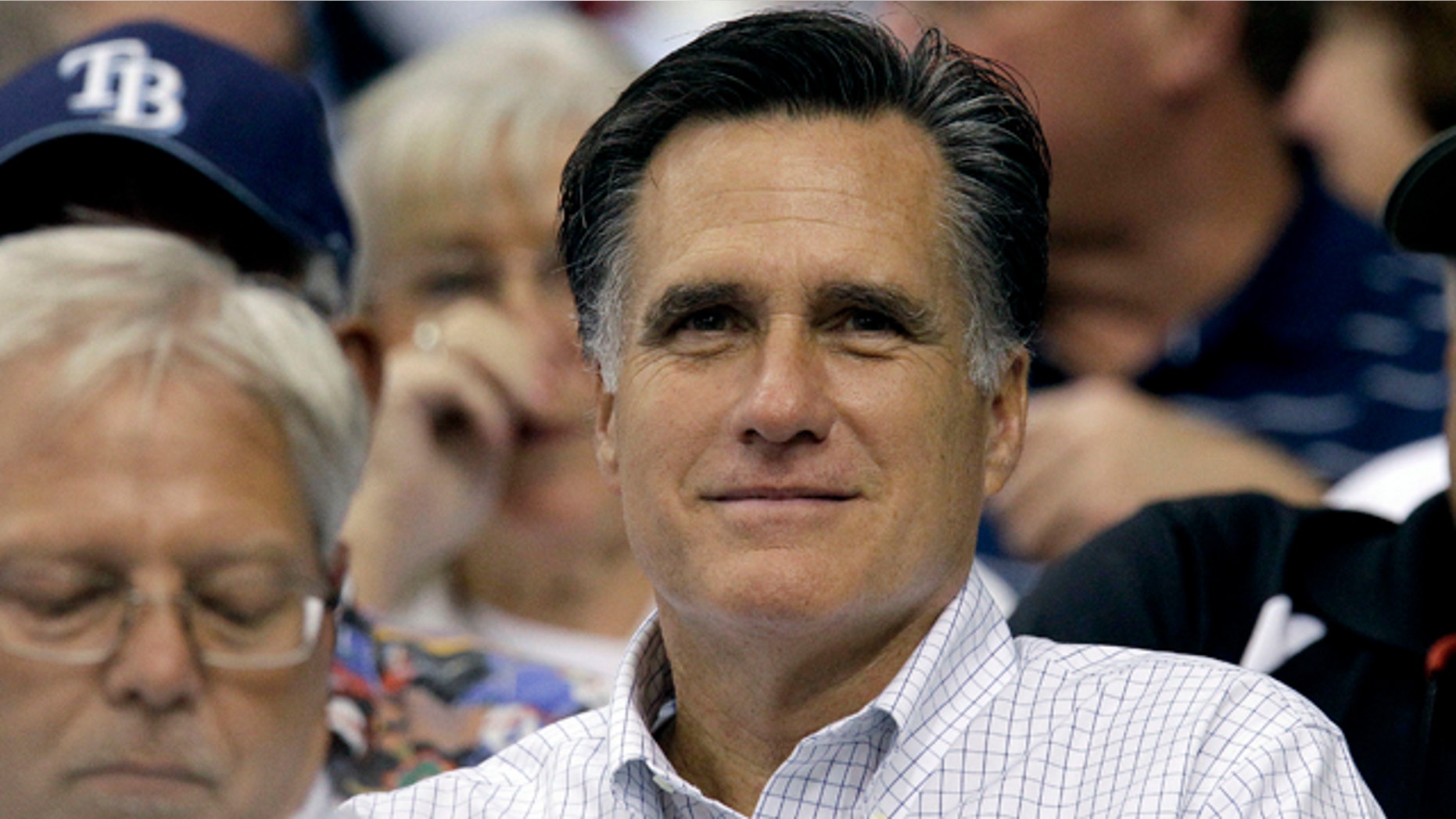 June 15: GOP hopeful Mitt Romney watches a baseball game between the Tampa Bay Rays and the Boston Red Sox. Perhaps there's no better evidence of his frontrunner status than the attacks leveled against his abortion stance by fellow candidates.