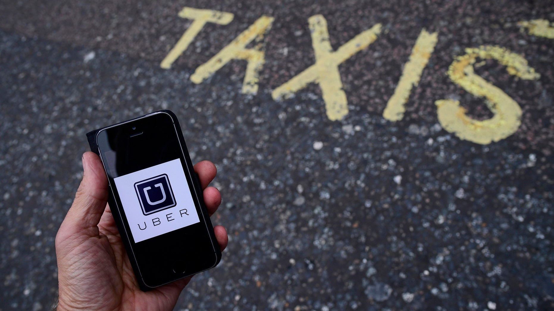 File photo: A photo illustration shows the Uber app logo displayed on a mobile telephone, as it is held up for a posed photograph in central London, Britain October 28, 2016. (REUTERS/Toby Melville)
