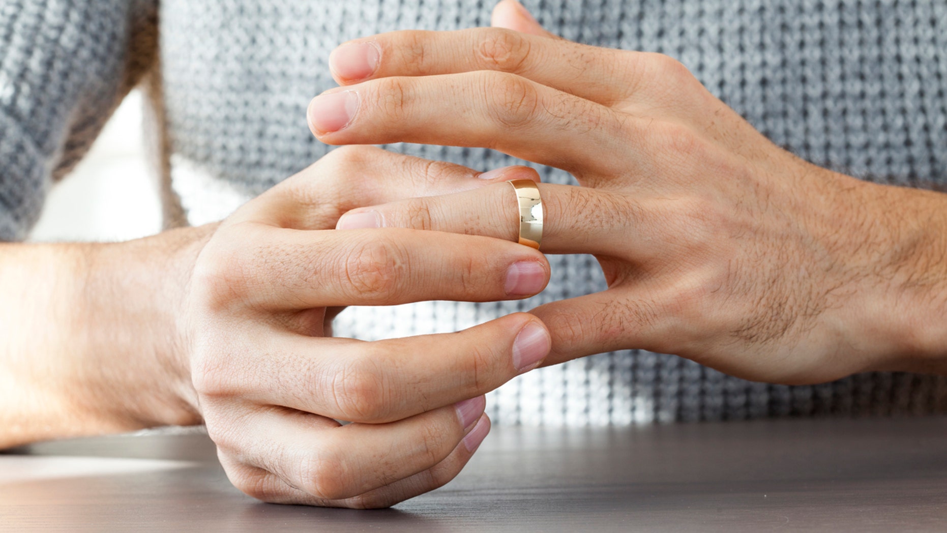 Man taking off wedding ring