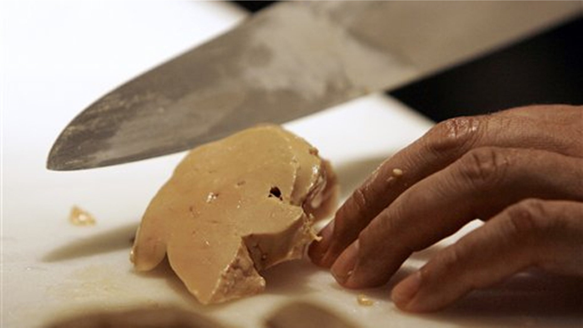 Todd Stein, the executive chef at MK in Chicago, slices a piece of foie gras.