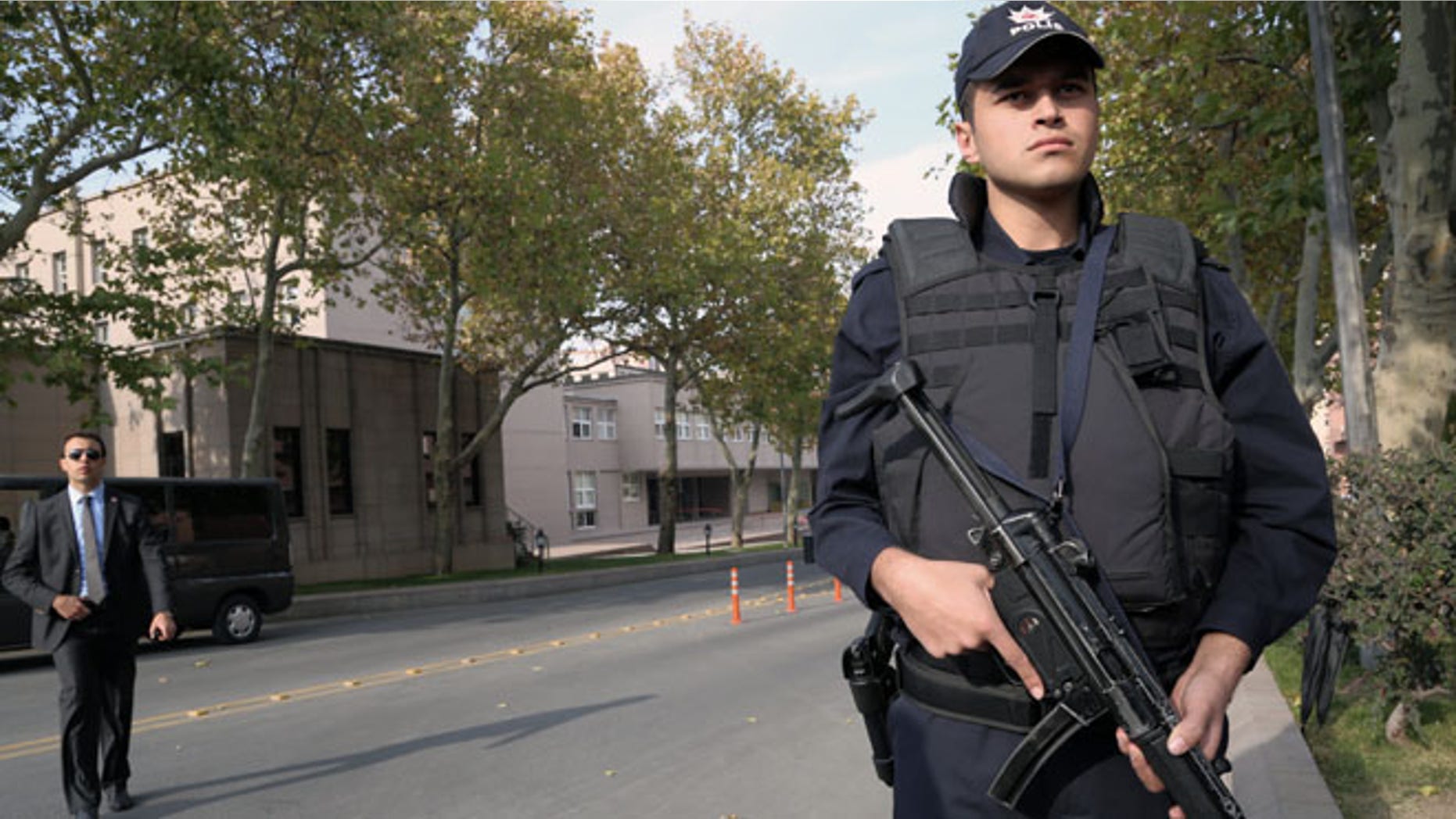 Nov. 21, 2013: Security officials close a road leading to Turkish Prime Minister Recep Tayyip Erdogans office, left in the background, shortly after police subdued a man who was carrying a fake bomb in Ankara, Turkey.