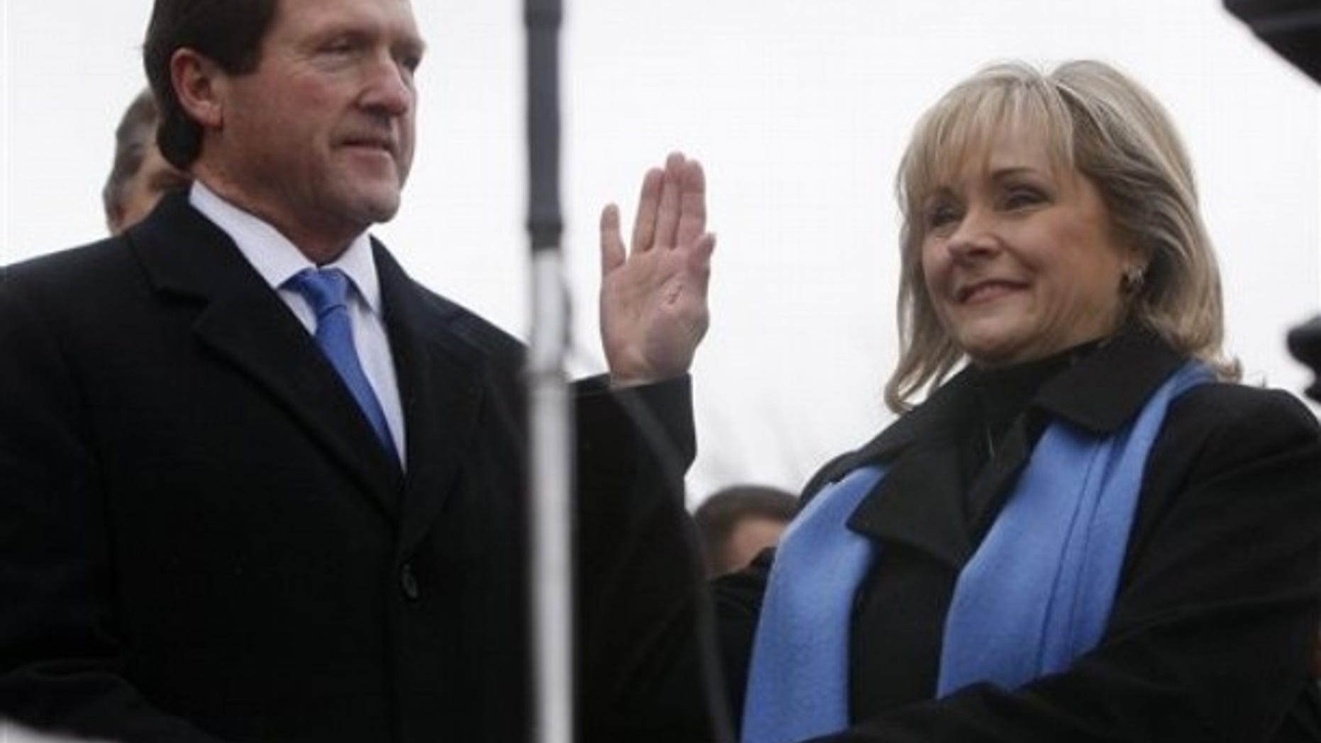 Monday: With her husband Wade Christensen at her side, Oklahoma Governor Mary Fallin takes her oath of office during her inauguration at the state Capitol in Oklahoma City.