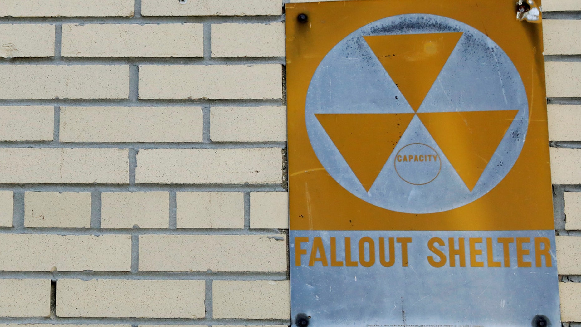 A yellow nuclear fallout shelter sign is seen hung on a building in Brooklyn earlier this month.