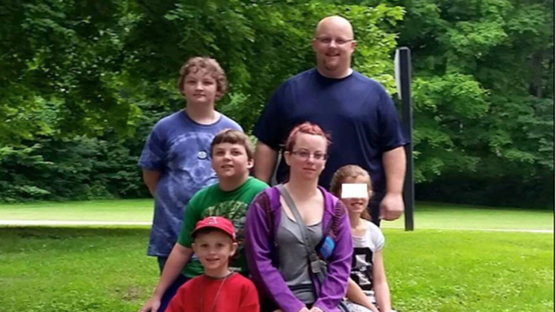 Kenneth and Colleen Shults with their children, including the foster daughter they hope to adopt, whose identity was intentionally obscured pending the case.