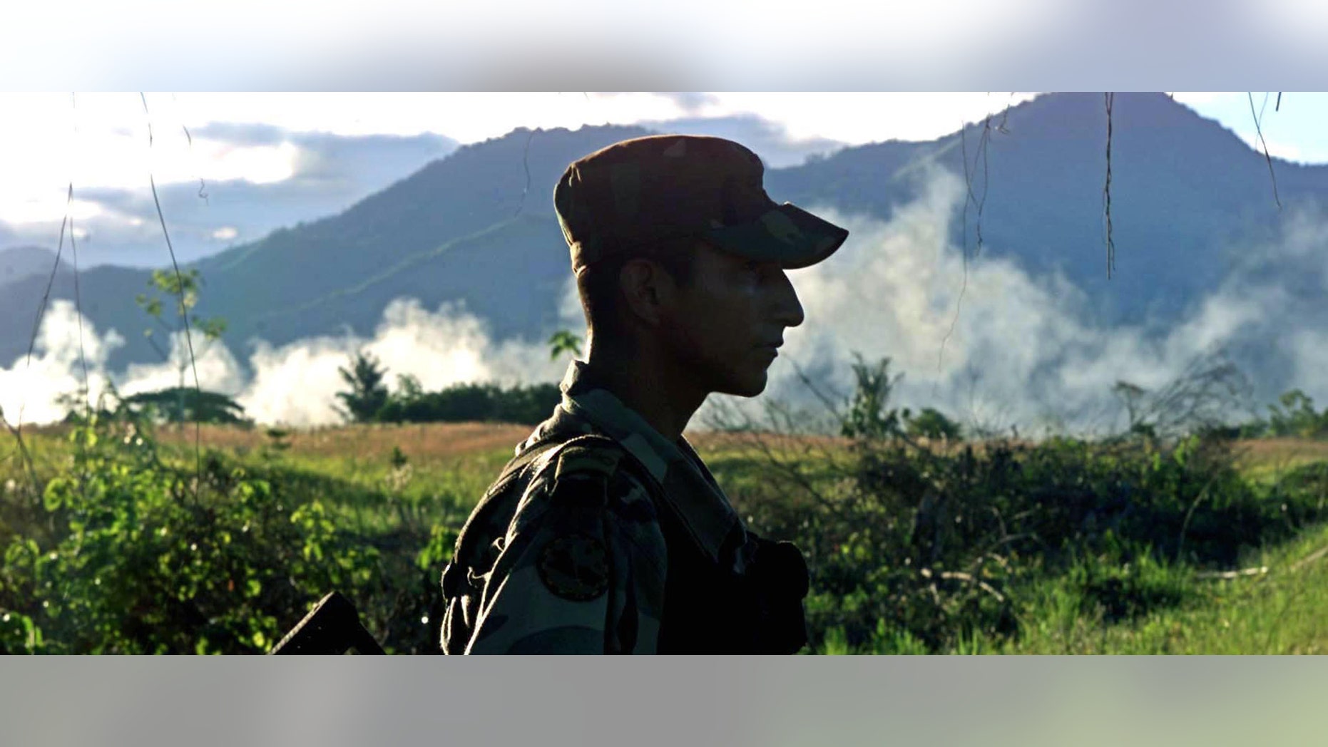 CAQUETA, COLOMBIA - JULY 31. A Colombian soldier patrols the highway that leads to San Vicente del Caguan from his base, Caqueta, Colombia on July 31, 2002. Despite a strong military presence in the former demilitarized zone, FARC guerrillas still maintain their control over the territories. (Photo by Carlos Villalon/Getty Images.)