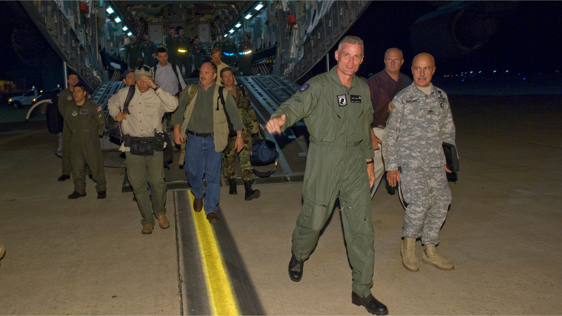 In a photo released by the the U.S. Air Force, Keith Stansell (3rd R) steps off the ramp of a C-17 Globemaster III July 2, 2008 at Lackland Air Force Base, Texas. Stansell, along with fellow military contractors Thomas Howes and Mark Gonsalves, was held captive for five years by the Revolutionary Armed Forces of Colombia (FARC).