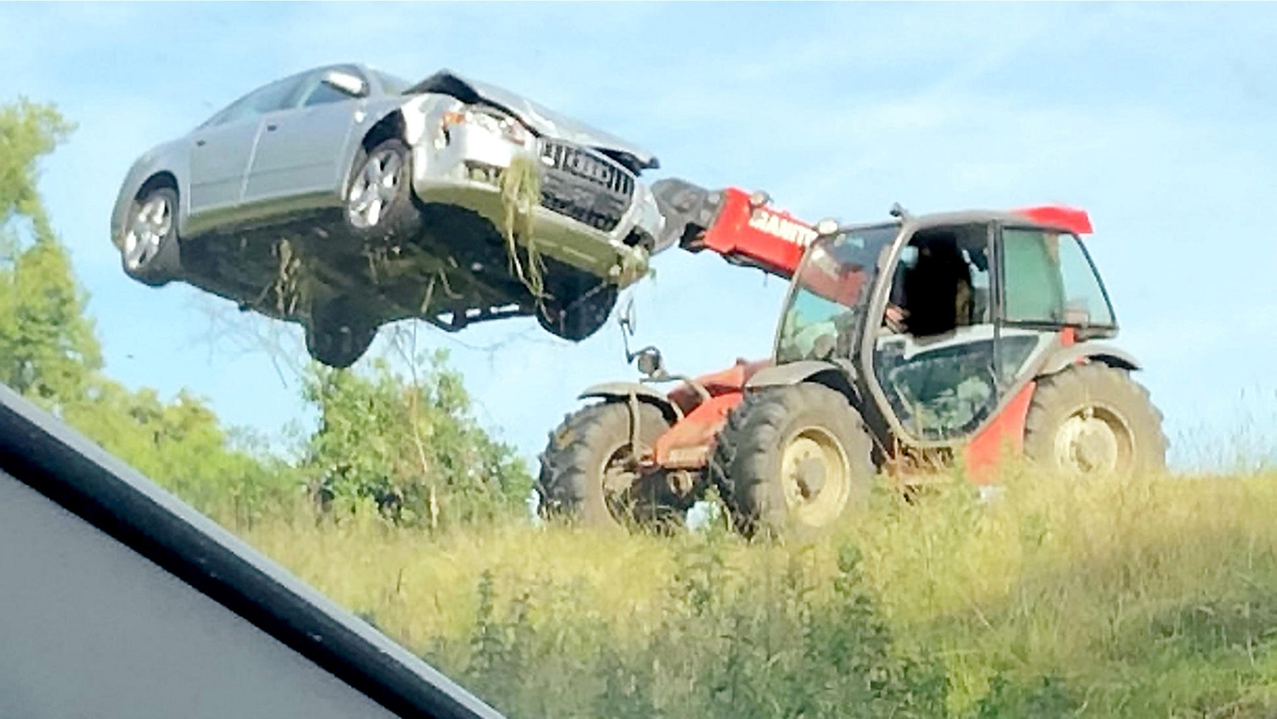 A farmer took matters into his own hands to remove a car which was abandoned in his field after the driver crashed and fled the scene. See MASONS story MNFIELD. The Audi A4 ran off the road and on to land containing livestock - before the occupant got out and disappeared. But the farmer wasn't hanging around for the driver to return and unceremoniously flung the car from his field in Ampthill, Beds., this morning (sun). Traffic cops tweeted pictures of the silver saloon being hoisted into the air by a piece of farming machinery.