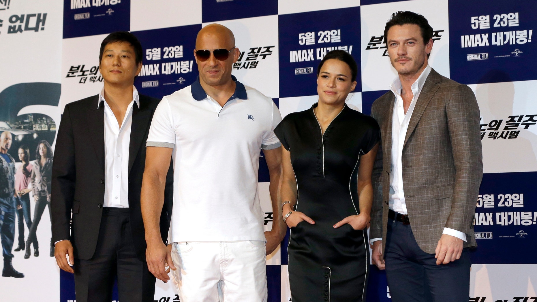 Actors and actress, from left, Sung Kang, Vin Diesel, Michelle Rodriguez and Luke Evans pose for the media during a press conference to promote their new film "Fast & Furious 6" in Seoul, South Korea, Monday, May 13, 2013.