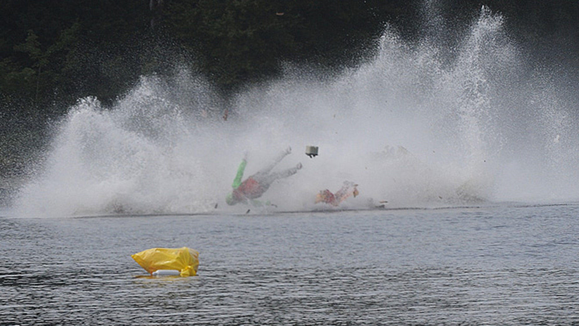One on the racers goes airborne during a fatal crash Saturday, Sept. 10, 2016, during the Bill Giles Memorial Regatta on Watson Pond in Taunton, Mass.