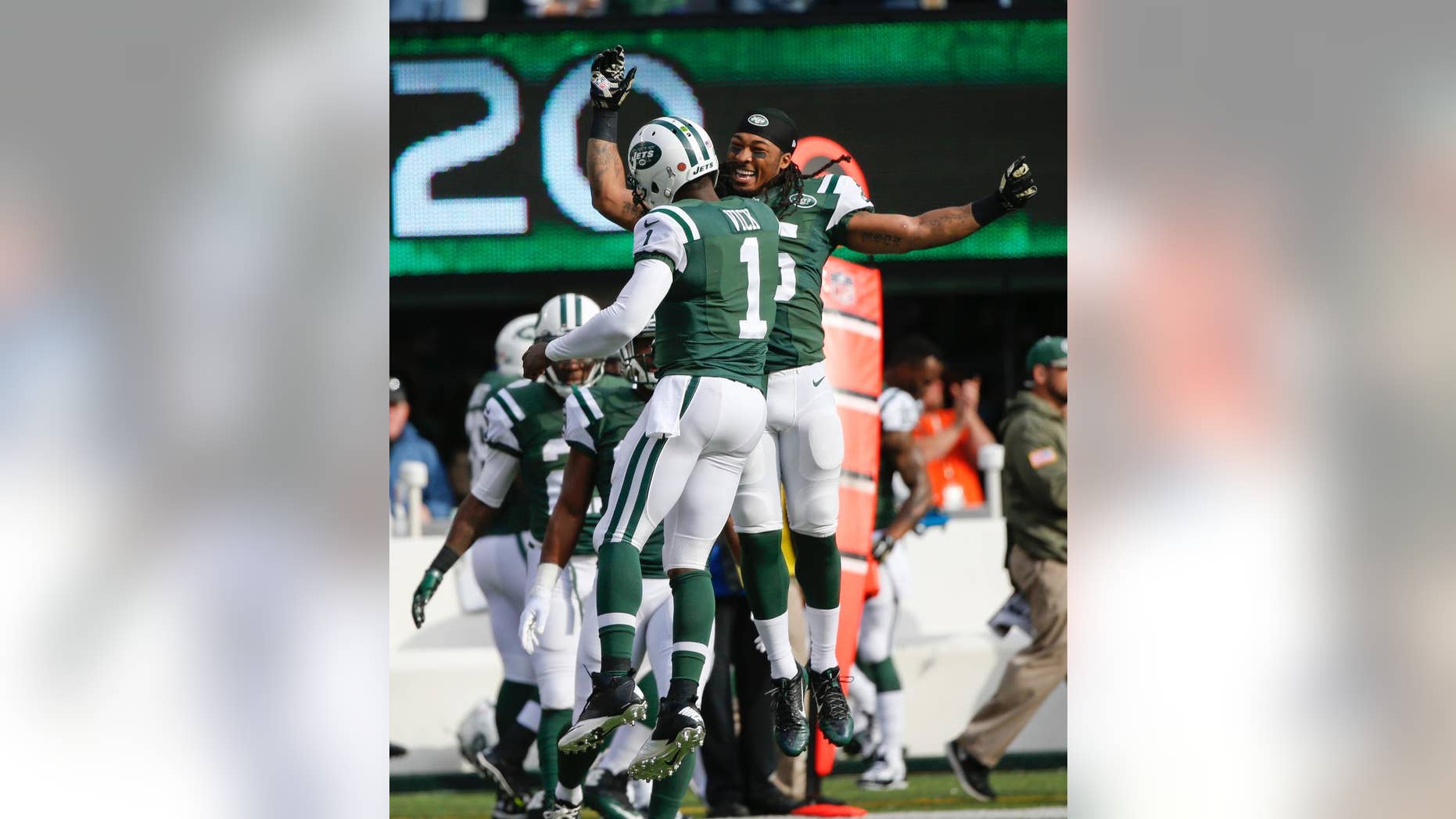 New York Jets quarterback Michael Vick (1) celebrates a touchdown with Calvin Pryor during the first half of an NFL football game against the Pittsburgh Steelers, Sunday, Nov. 9, 2014, in East Rutherford, N.J. (AP Photo/Kathy Willens)