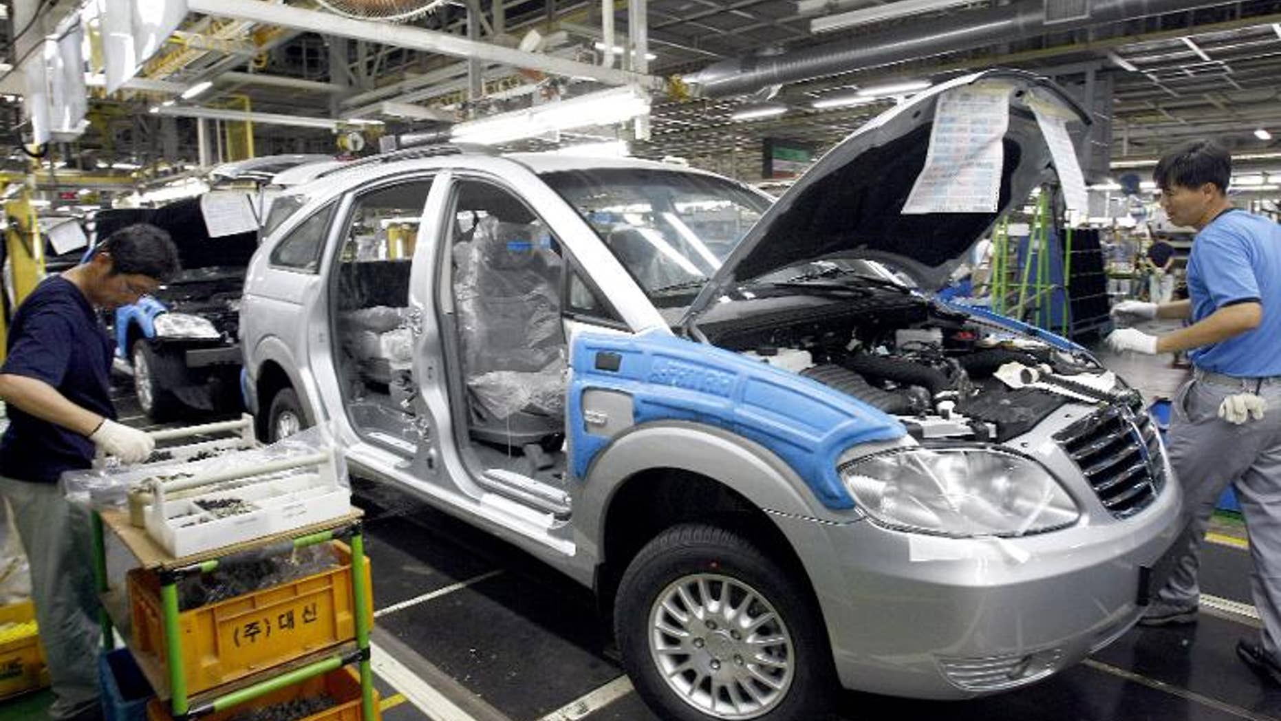 Illustration: Ssangyong Motor workers assemble cars on the production line in Pyeongtaek, South Korea
