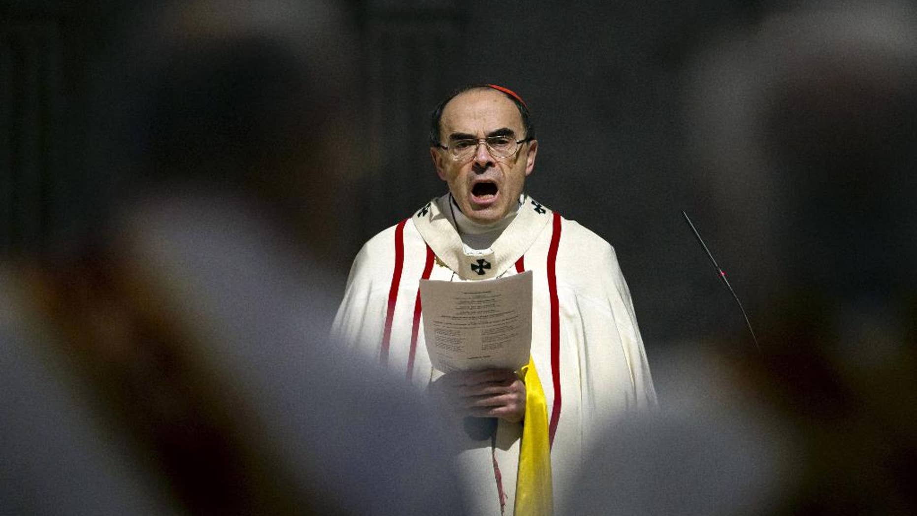 FILE - In this April 3, 2016 photo, French Cardinal Philippe Barbarin, Archbishop of Lyon, leads a mass for migrants, in Lyon, central France. Police are questioning a prominent French cardinal about alleged failure to report pedophile priests under his watch. (AP Photo/Laurent Cipriani, File)