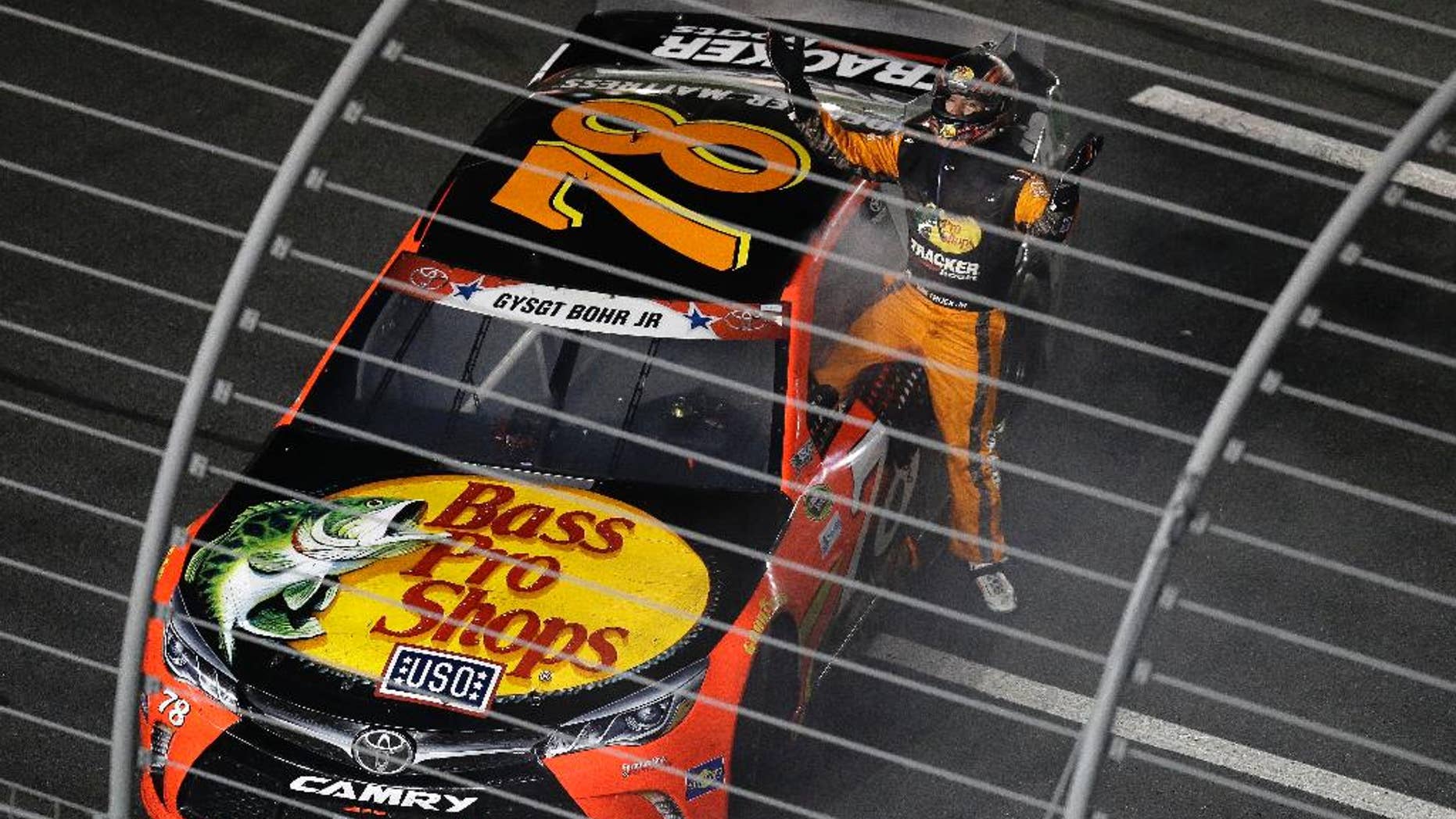 Martin Truex Jr. (78) celebrates after winning the NASCAR Sprint Cup Series auto race at the Charlotte Motor Speedway in Concord, N.C., Sunday, May 29, 2016. (AP Photo/Gerry Broome)