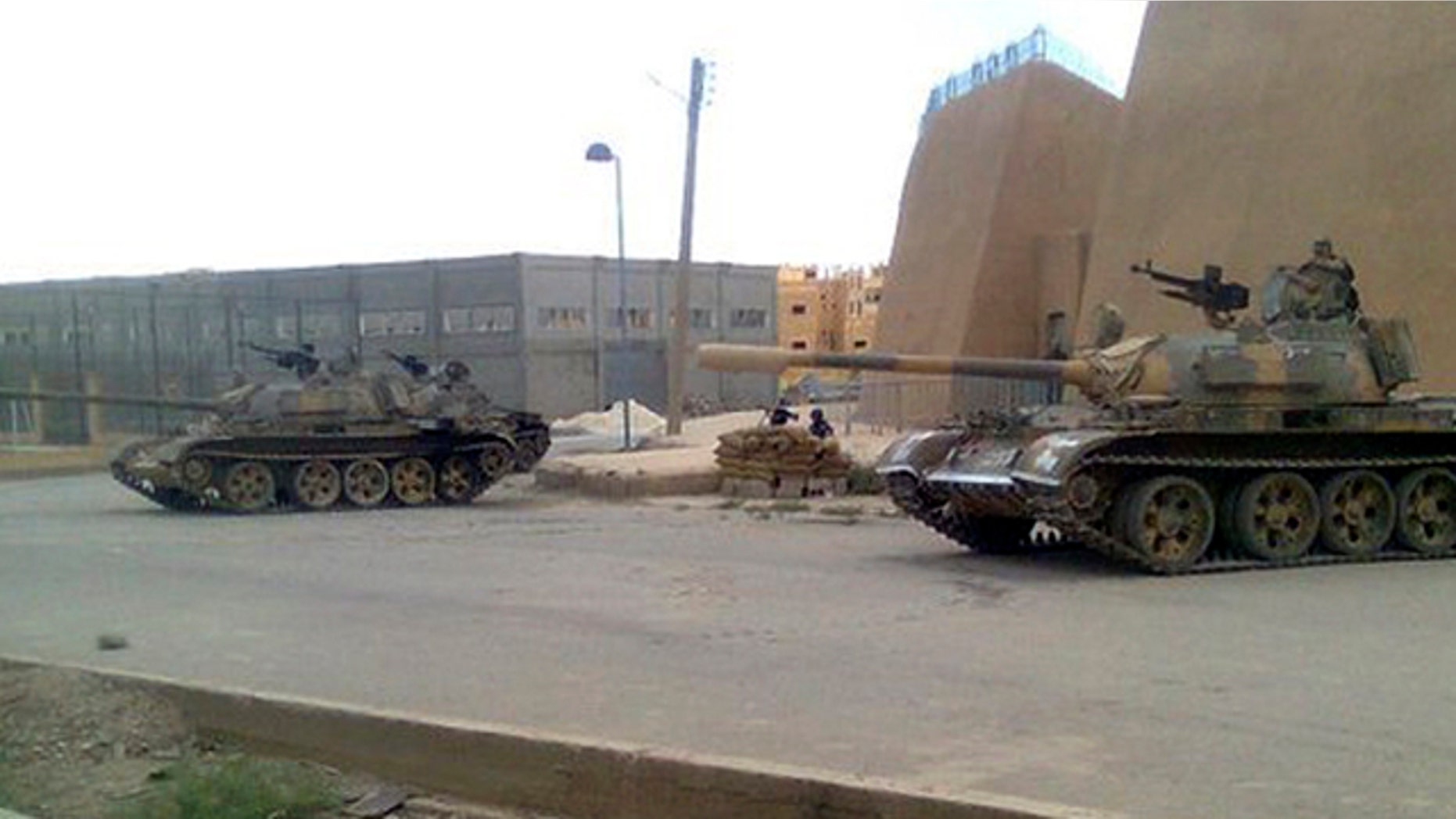 June 14: In this citizen journalism image made on a mobile phone and provided by Shaam News Network, a Syrian army tank is deployed in the Syrian eastern province of Deir el-Zour, Syria.