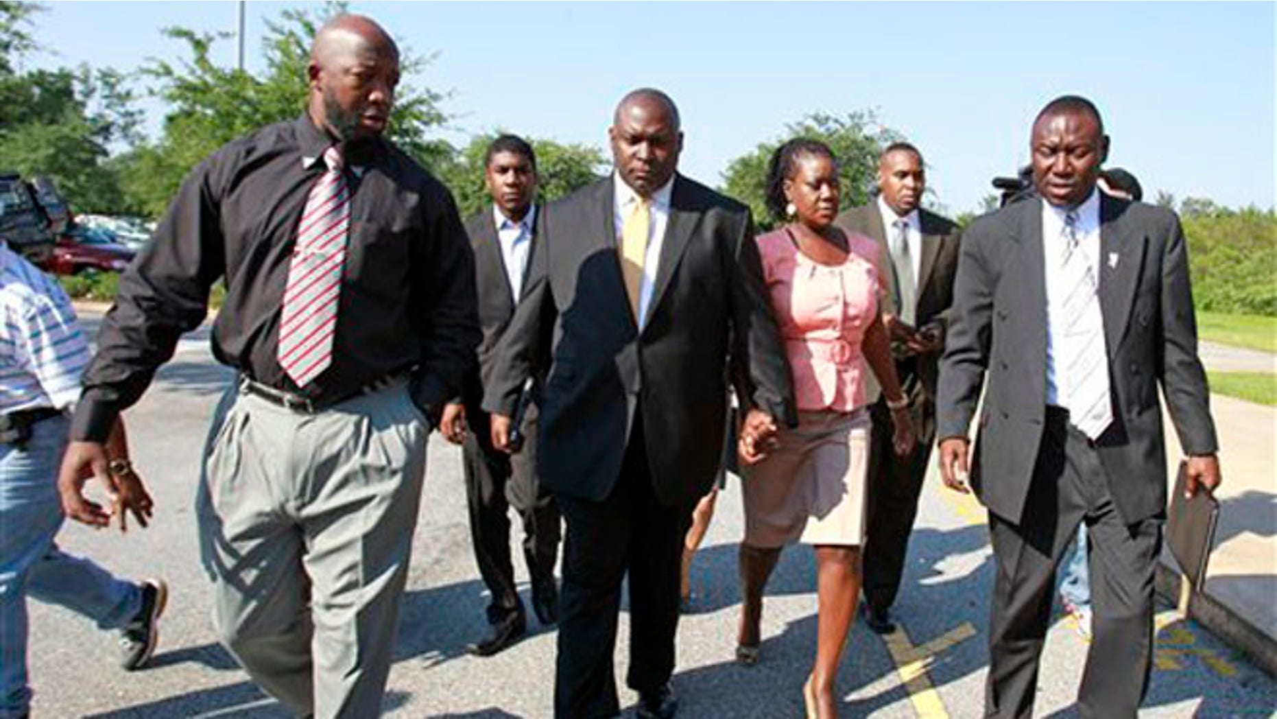 June 29, 2012: Tracy Martin, far left, father of Trayvon Martin; Jahvaris Fulton, second from left, brother of Trayvon Martin; attorney Daryl Parks, center, Sybrina Fulton, mother of Trayvon Martin and attorney Benjamin Crump, far far right, arrive at the Seminole County Criminal Justice Center to attend a bond hearing for George Zimmerman in Sanford, Fla.