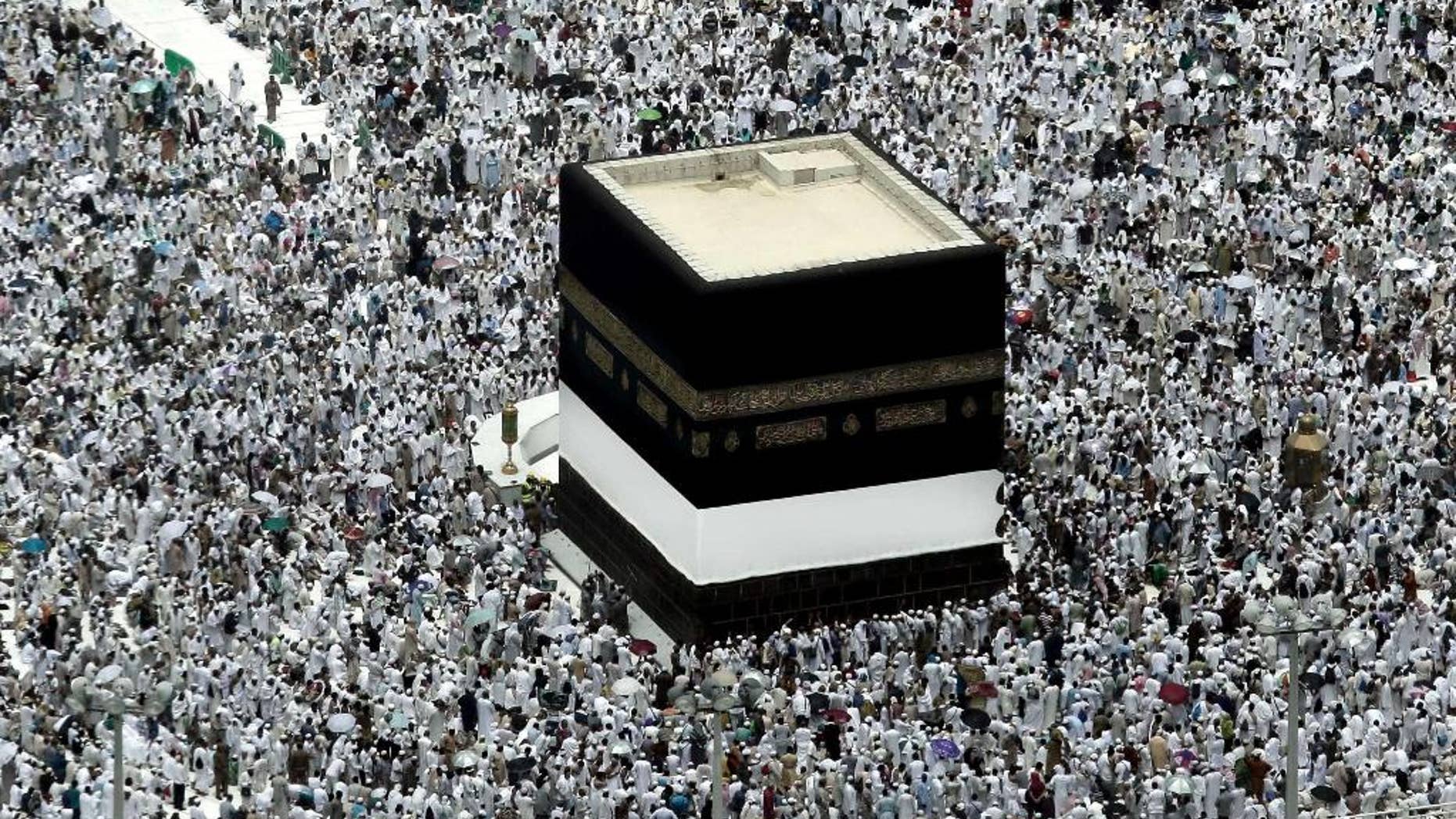 FILE - In this Friday, Sept. 9, 2016 file photo, Muslim pilgrims prepare themselves for Friday prayers in front of the Kaaba, Islam's holiest shrine, at the Grand Mosque in the Muslim holy city of Mecca, Saudi Arabia. In recent years, Christians have had more babies than any other religious group worldwide. But by 2035, Muslims are projected to experience the higher birth rate, putting the world’s two largest religions on track to have a near equal share of the global population by 2060, according to a demographic analysis released Wednesday. (AP Photo/Nariman El-Mofty)
