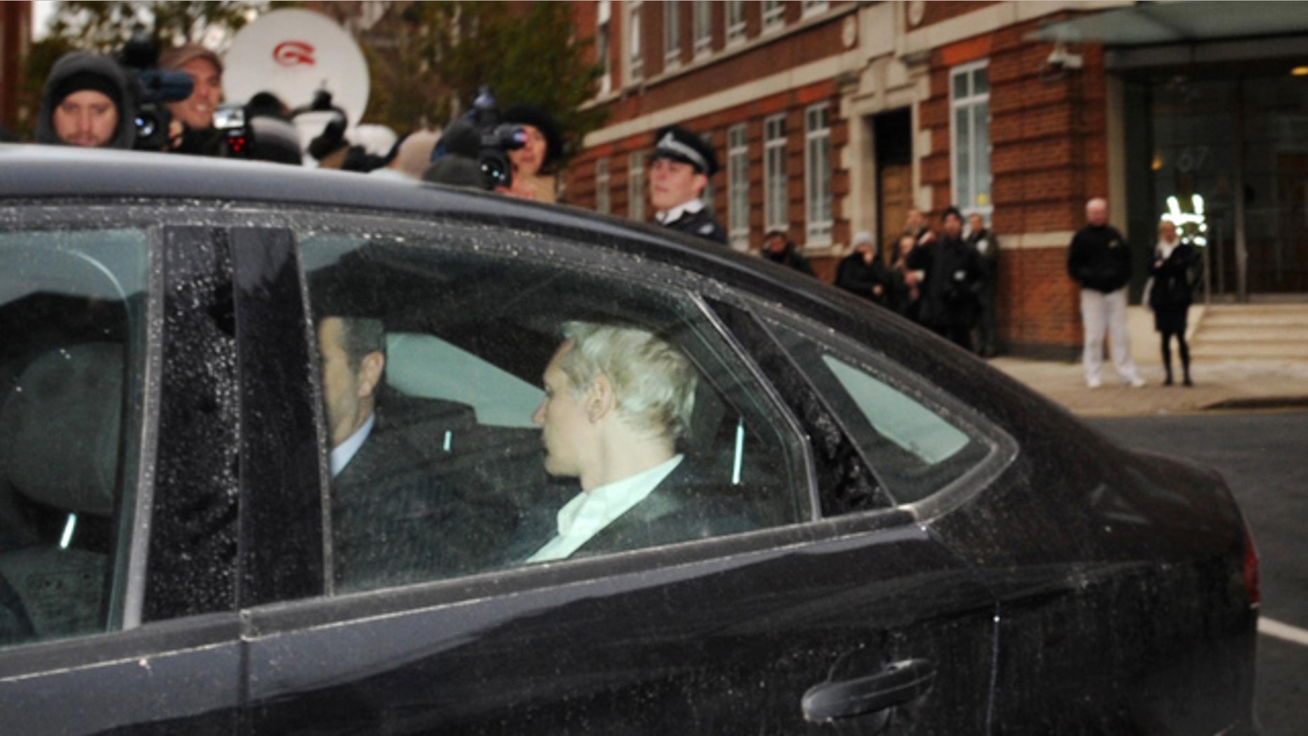 Dec. 7: WikiLeaks founder Julian Assange, back to camera, is driven into Westminster Magistrates Court in London after being arrested on a European Arrest Warrant.