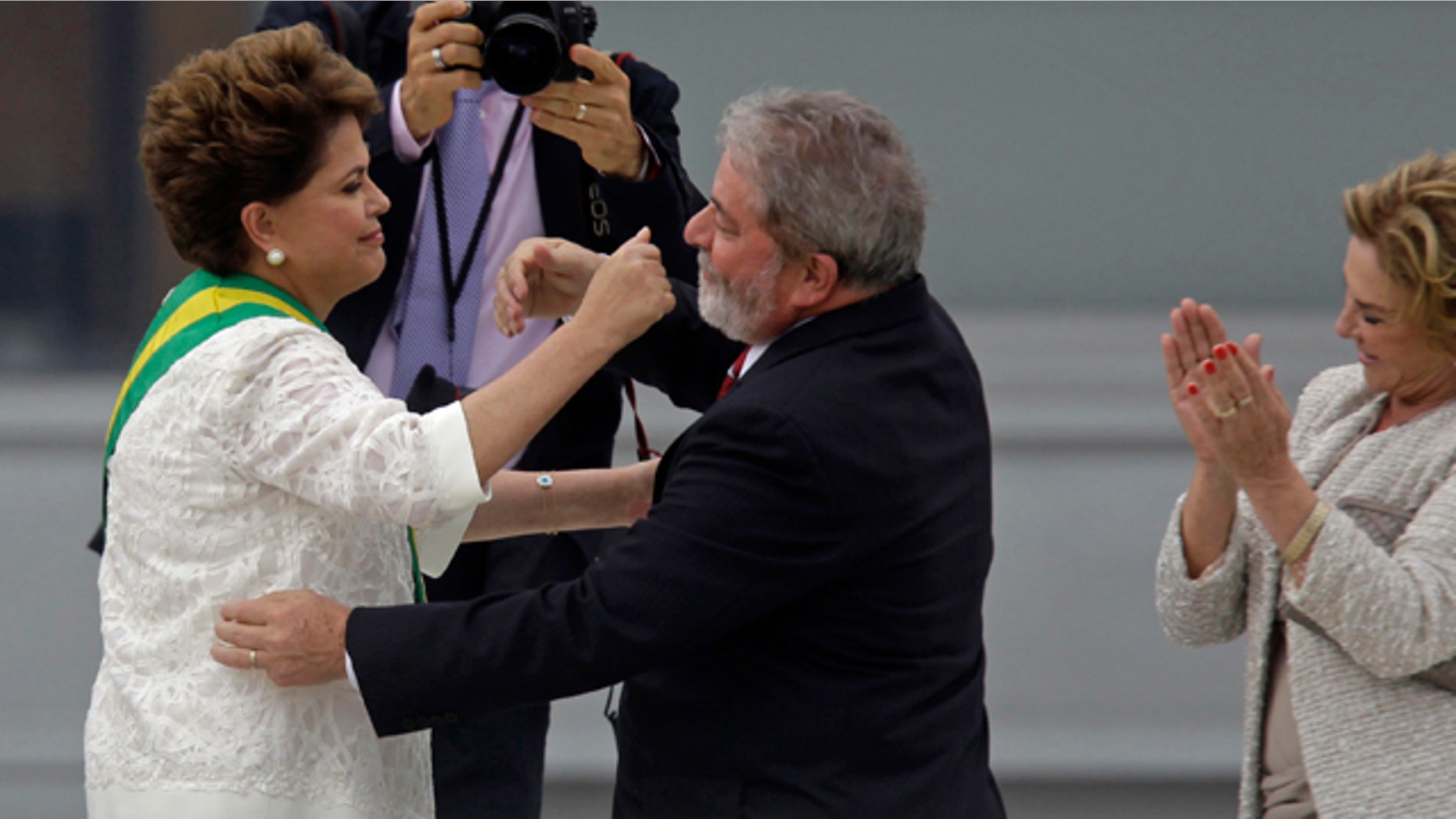 Jan. 1, 2011: Brazil´s outgoing President Luiz Inacio Lula da Silva embraces Brazil's President Dilma Rousseff after placing the presidential sash on her at the Planalto palace in Brasilia, Brazil