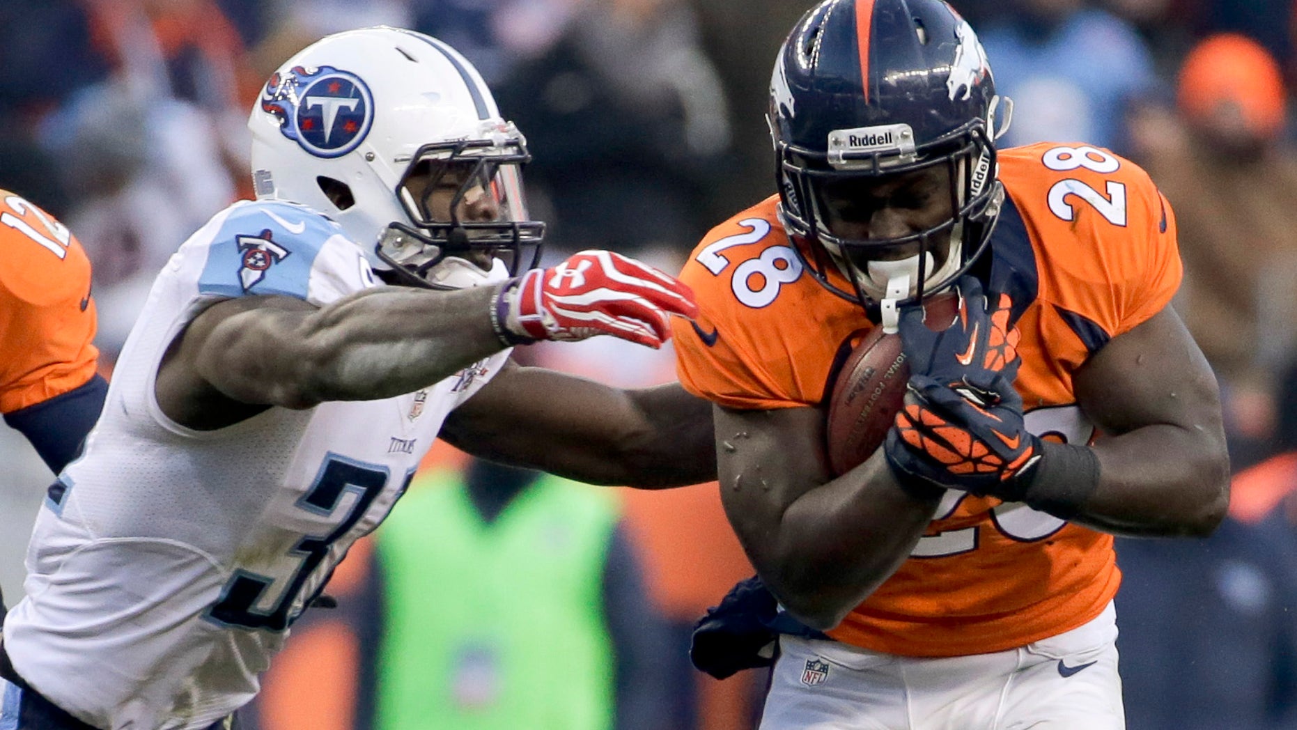 Tennessee Titans strong safety Bernard Pollard, left, tackles Denver Broncos running back Montee Ball during the second half of an NFL football game on Sunday, Dec. 8, 2013, in Denver. (AP Photo/Jack Dempsey)